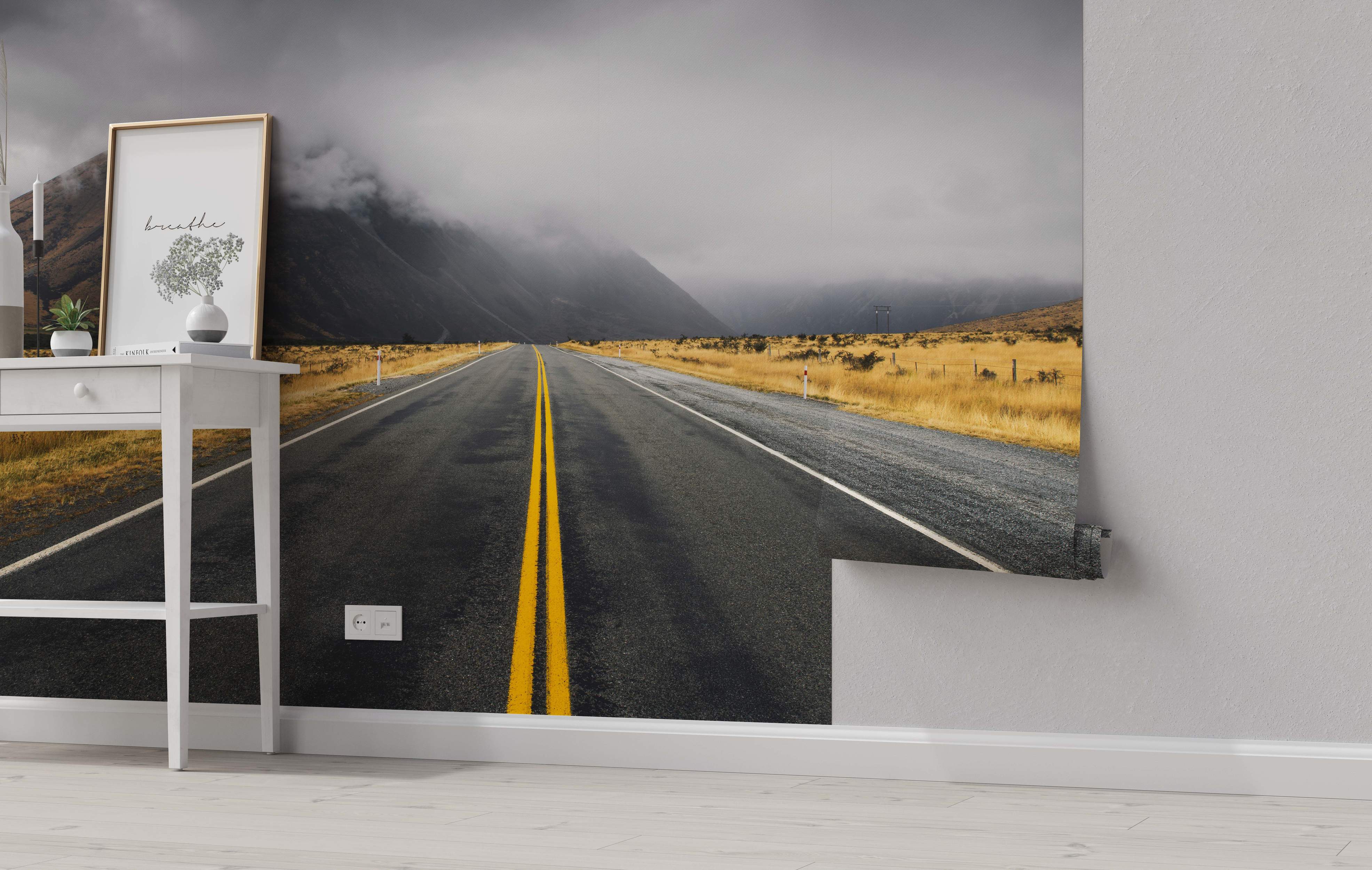 Road through a mountainous landscape mural with yellow lines