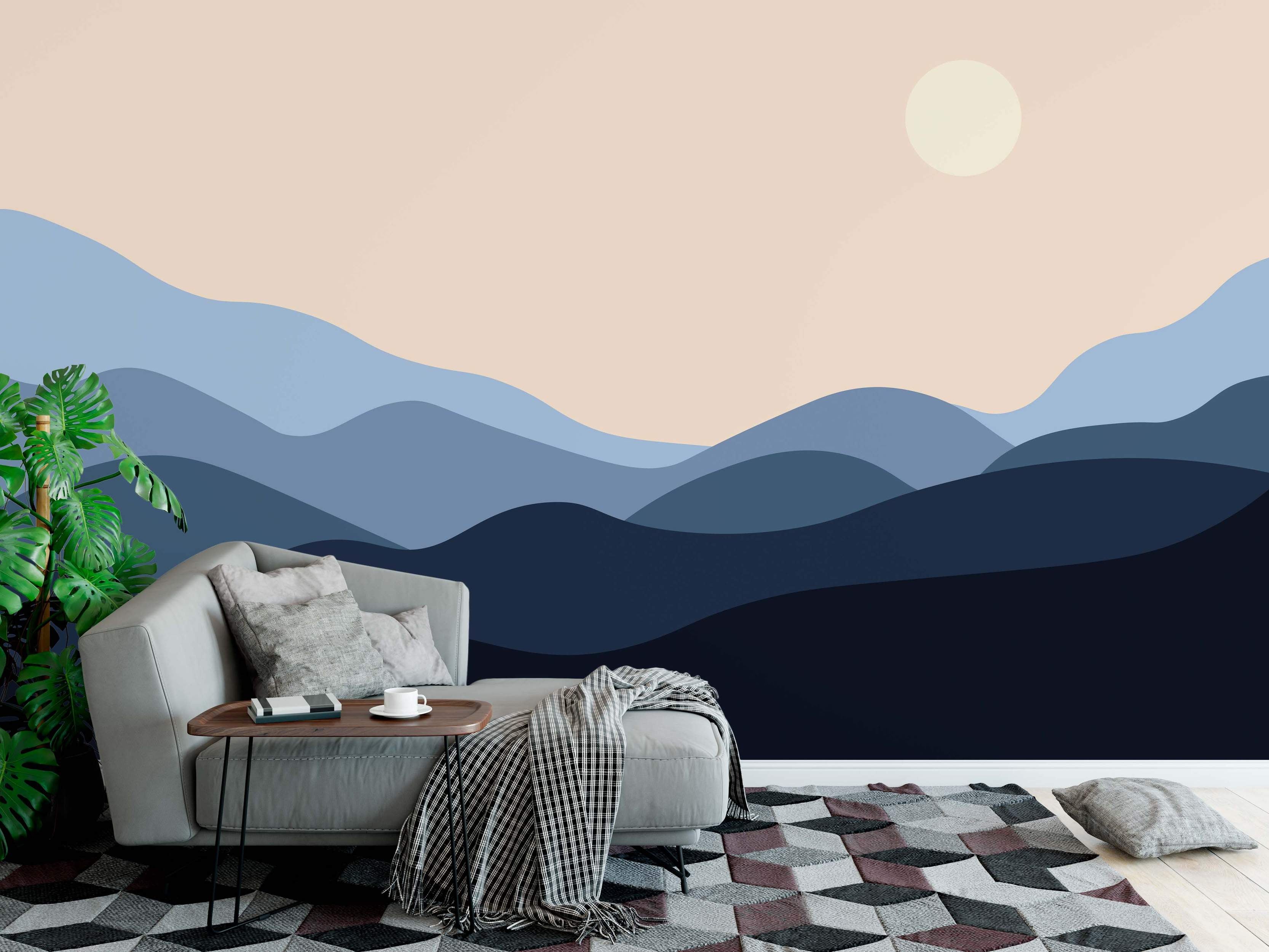 Minimalist landscape mural featuring rolling hills in layered shades of blue beneath a pale beige sky with a cream sun.