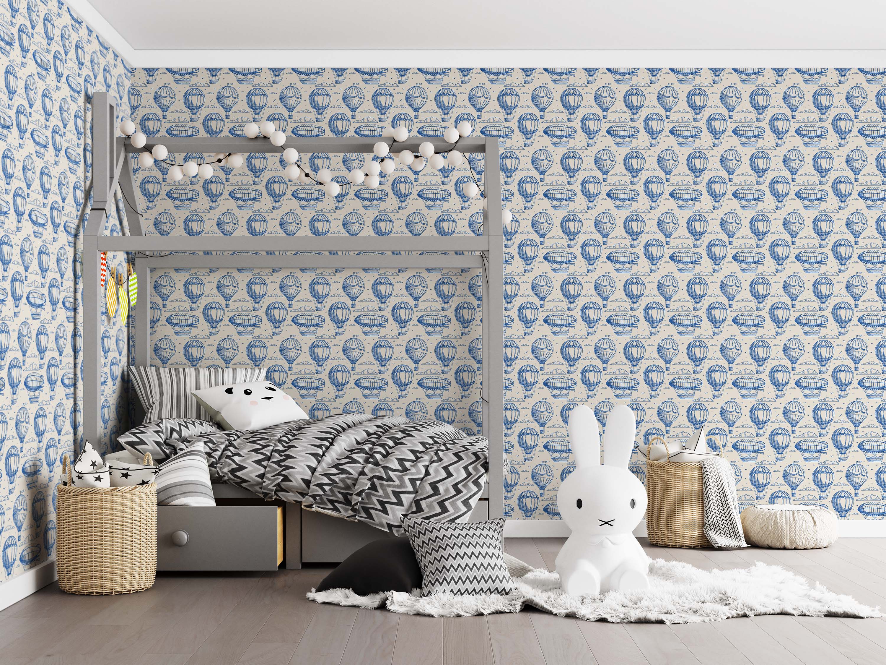 A vintage-style wallpaper featuring a repeating pattern of blue-inked hot air balloons and zeppelins on a cream background.
