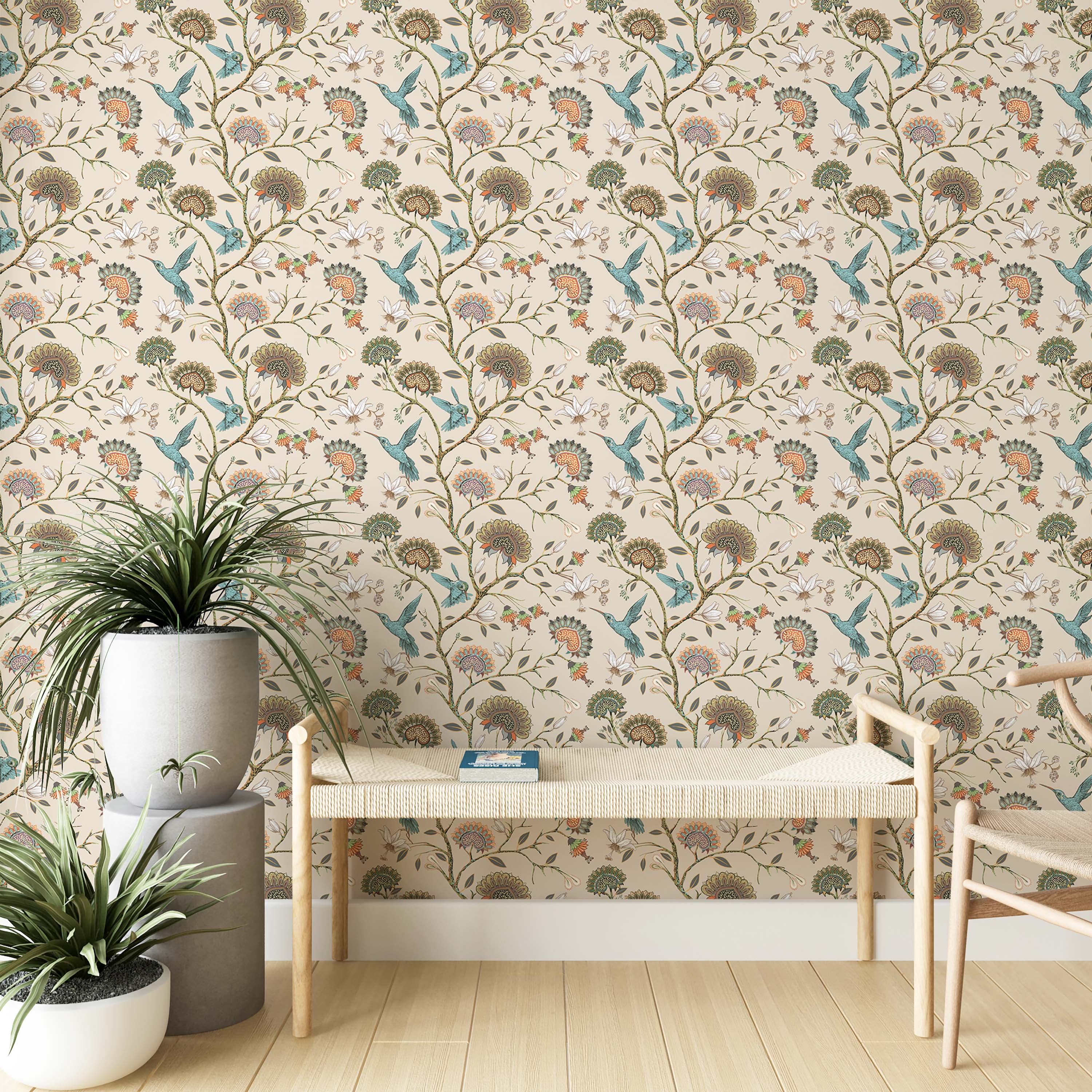 A repeating wallpaper pattern of teal hummingbirds and stylized floral vines in orange, green, and brown on a cream background.