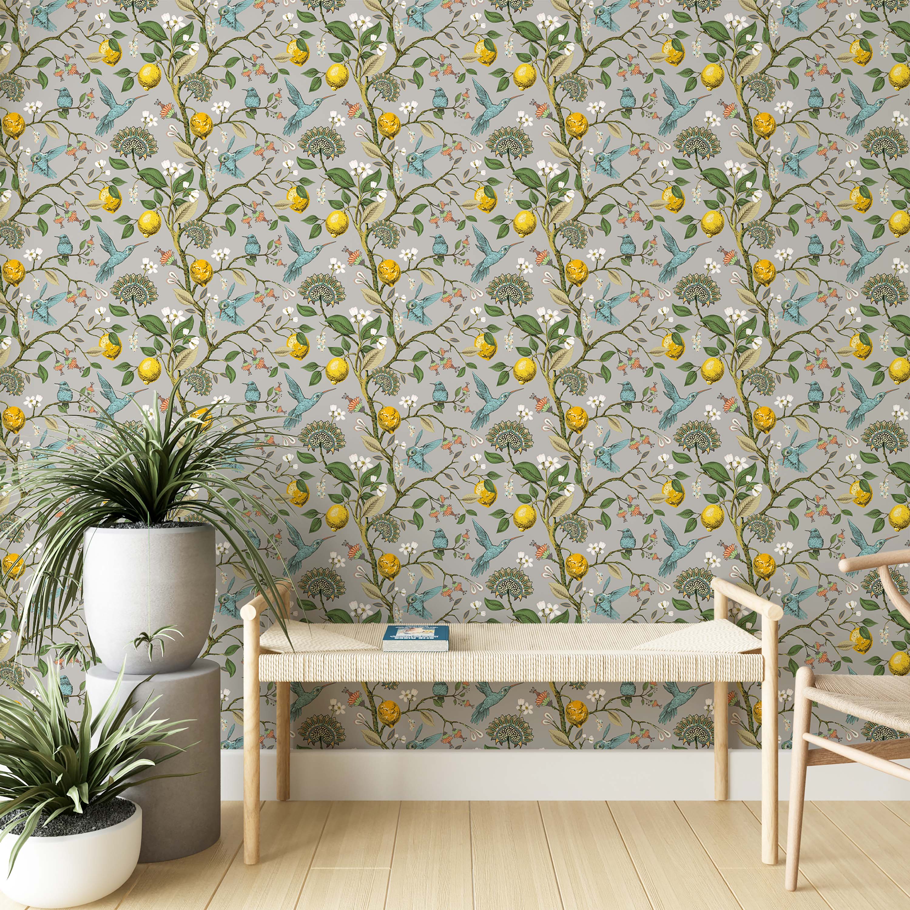A botanical wallpaper with blue hummingbirds, yellow lemons, and white flowers on twisting branches against a gray background.