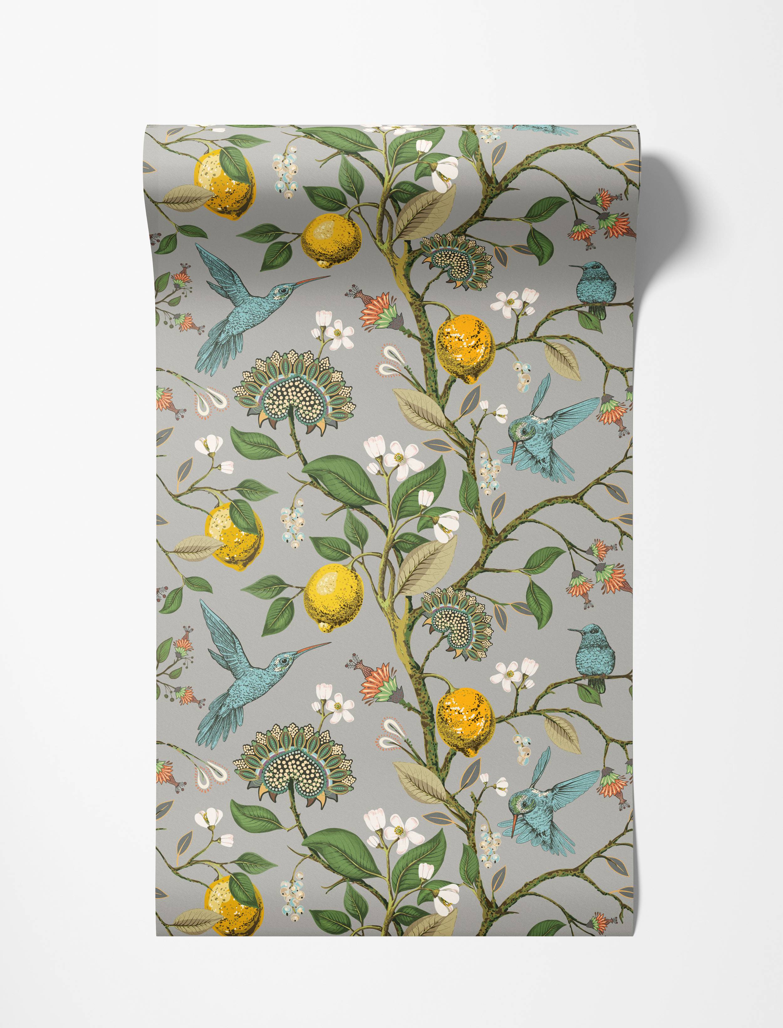 A botanical wallpaper with blue hummingbirds, yellow lemons, and stylized flowers on a gray background.