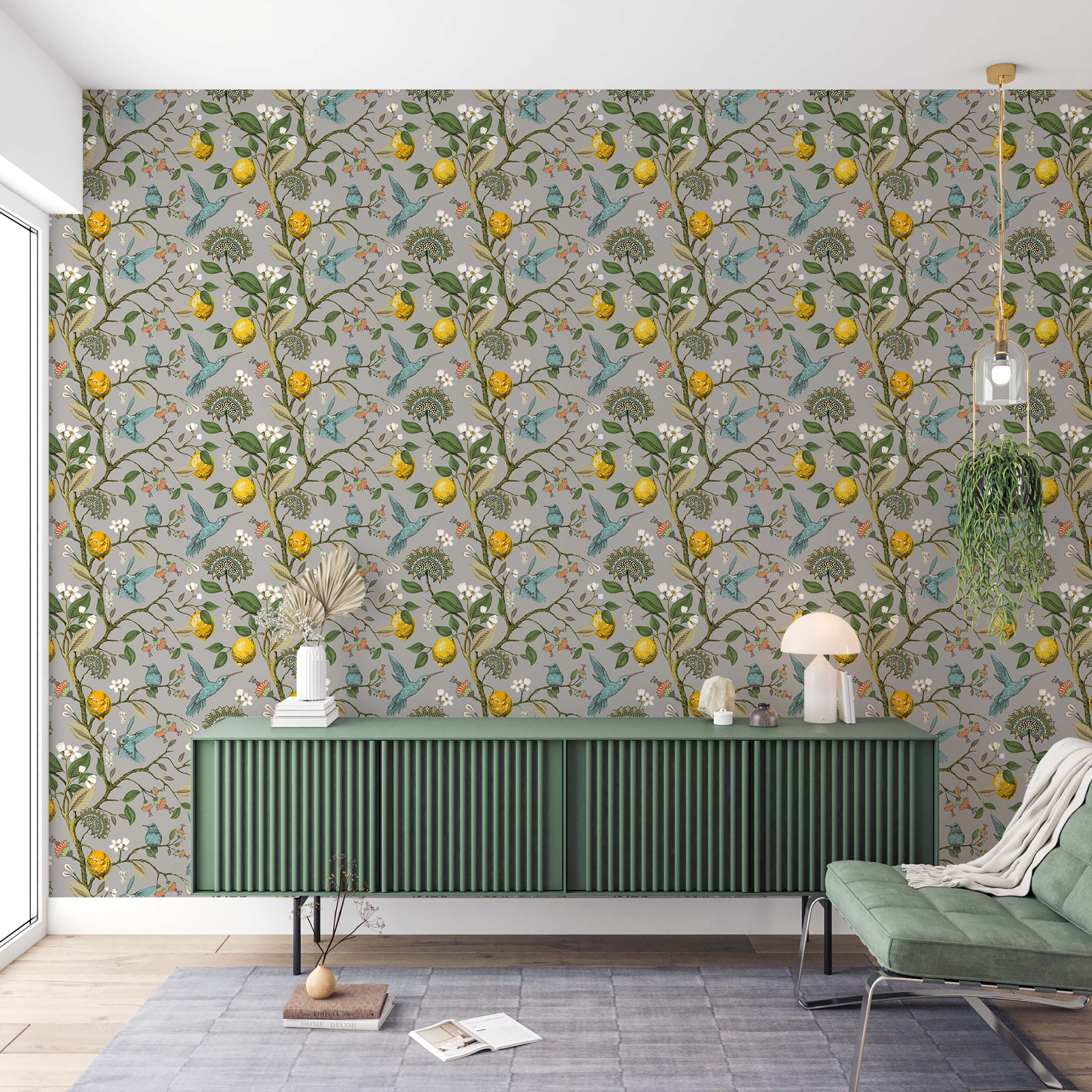 A botanical wallpaper with blue hummingbirds, yellow lemons, and white flowers on trailing vines against a gray background.