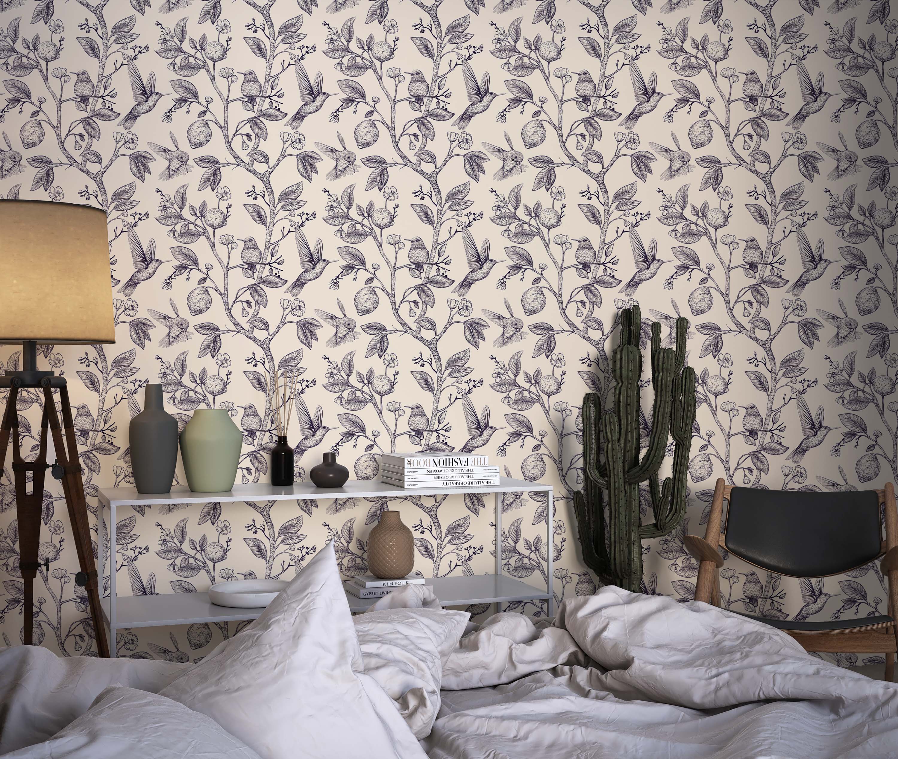 Vintage-style wallpaper with an illustrative pattern of hummingbirds, lemons, and branches in dark blue on a cream background.
