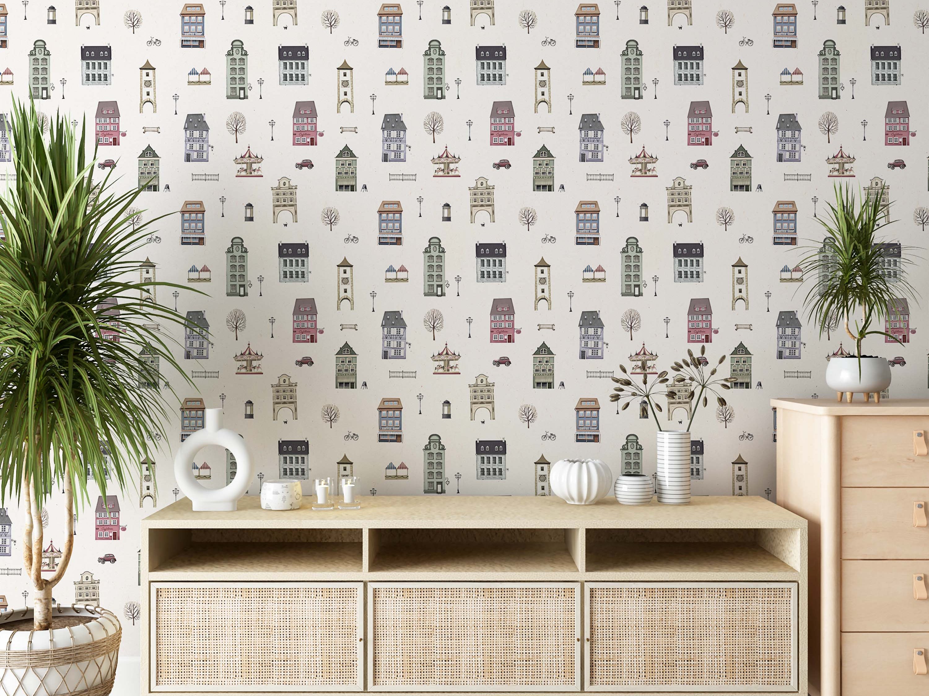 Wallpaper featuring a repeating illustrated town pattern with pastel-colored buildings, trees, and carousels on a light background.