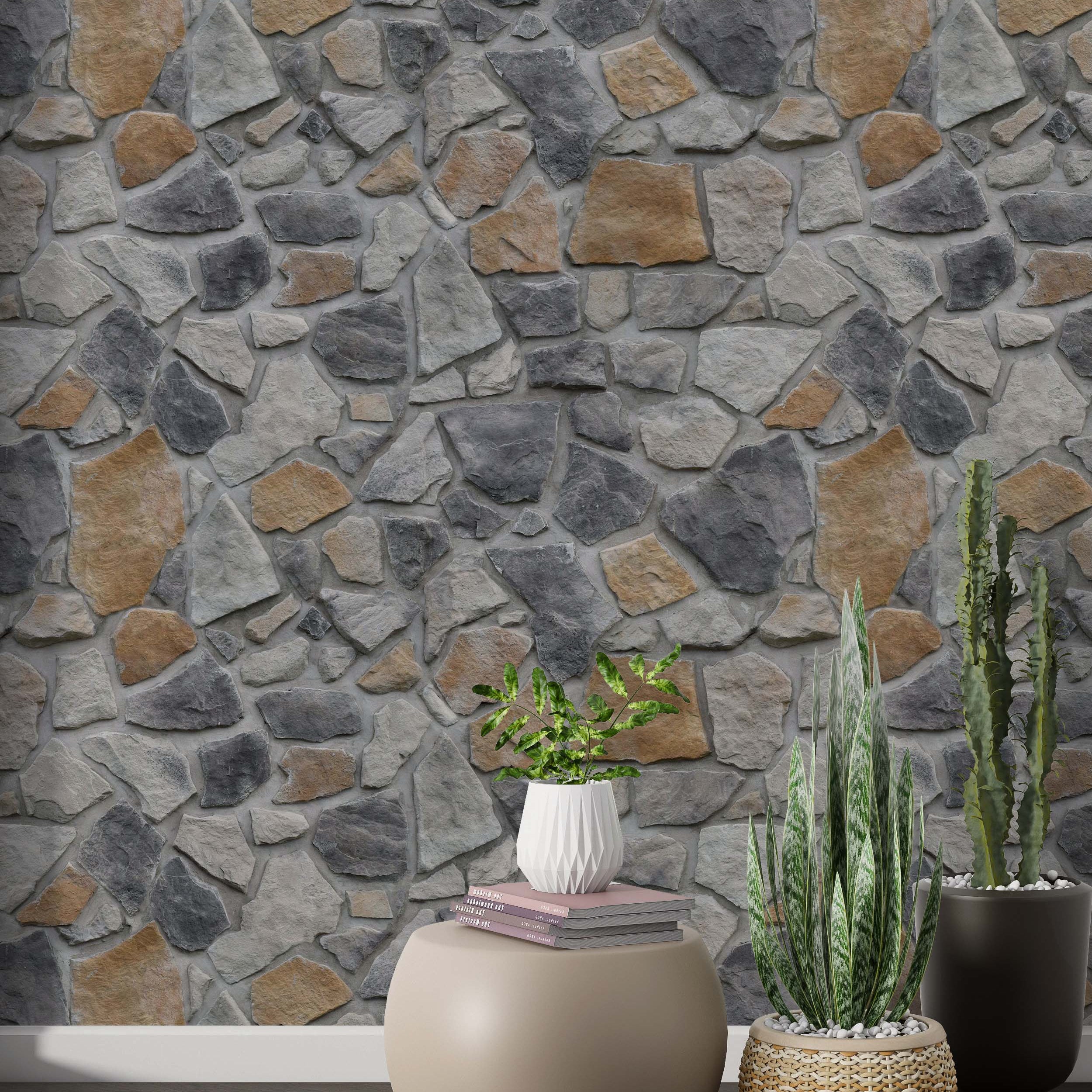 Wallpaper showcasing an irregular fieldstone pattern with stones in various shades of gray and earthy tan, creating a rustic look.