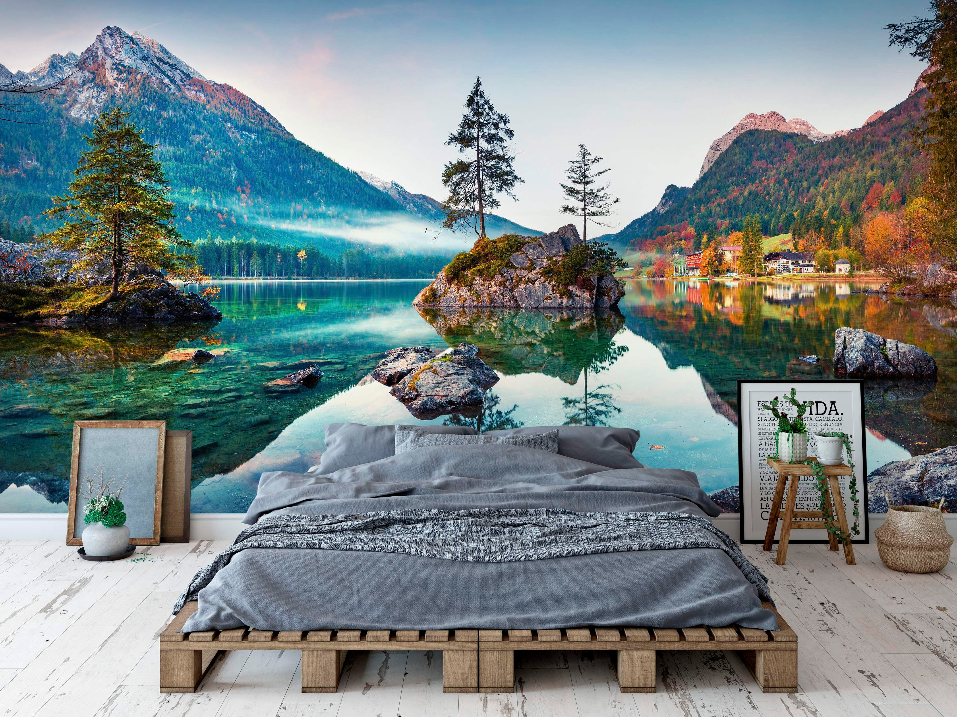 Mural depicting a clear blue-green alpine lake with a tree-covered island reflecting autumn mountains.