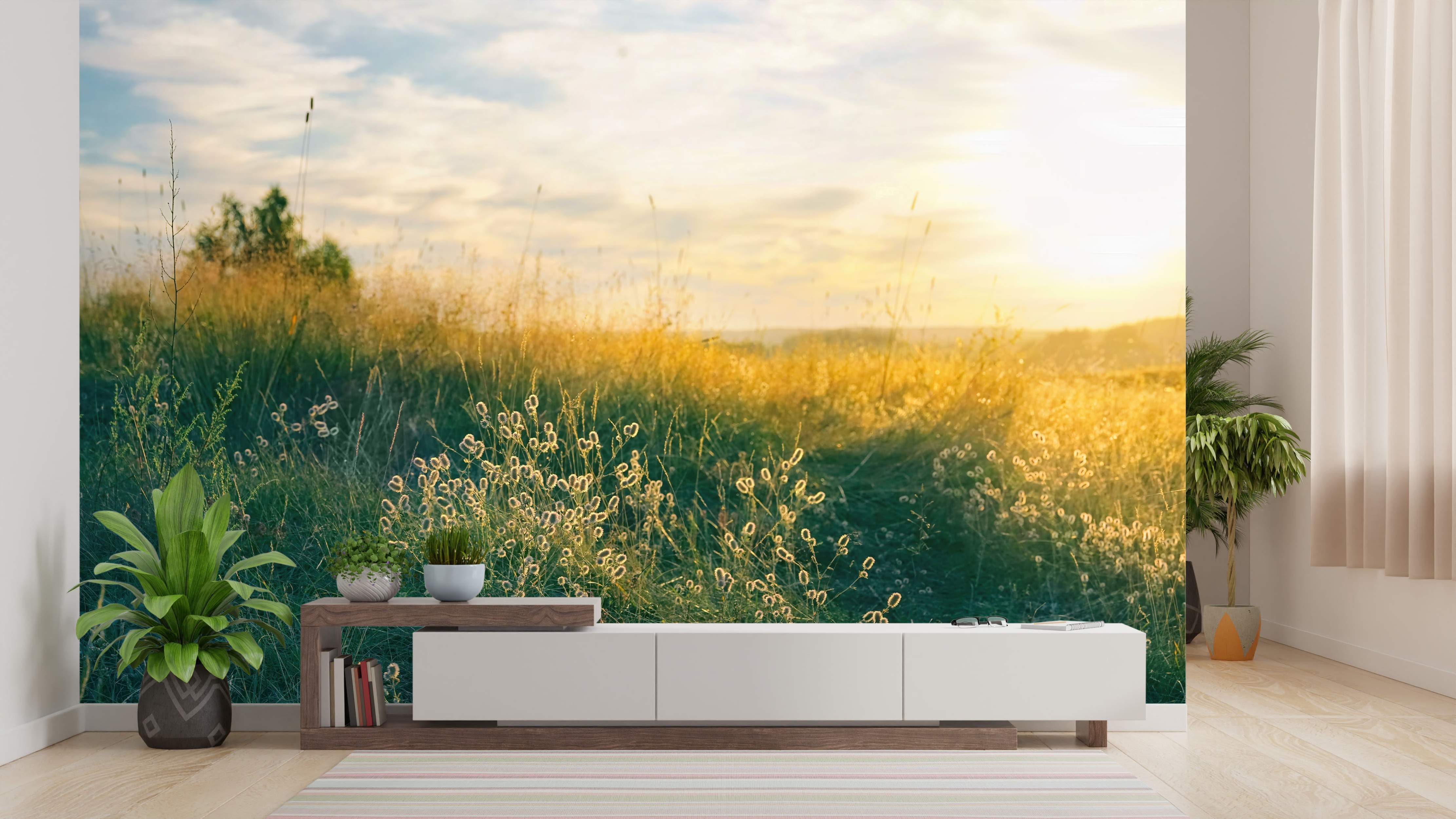 Photorealistic mural of a grassy field with wildflowers glowing in the golden light of a sunset under a soft blue sky.