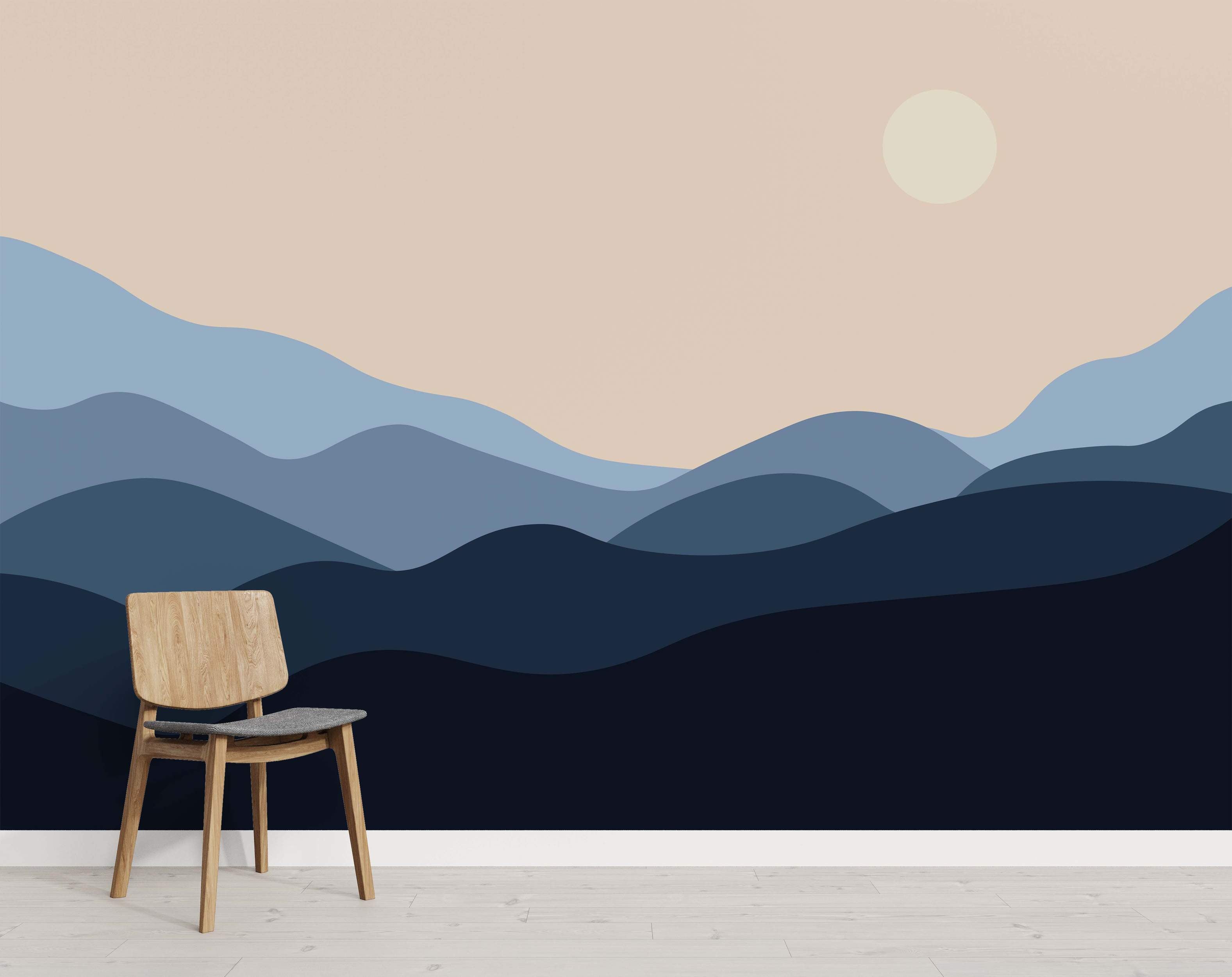Minimalist landscape mural featuring rolling hills in shades of blue under a pale beige sky with a light yellow sun/moon.