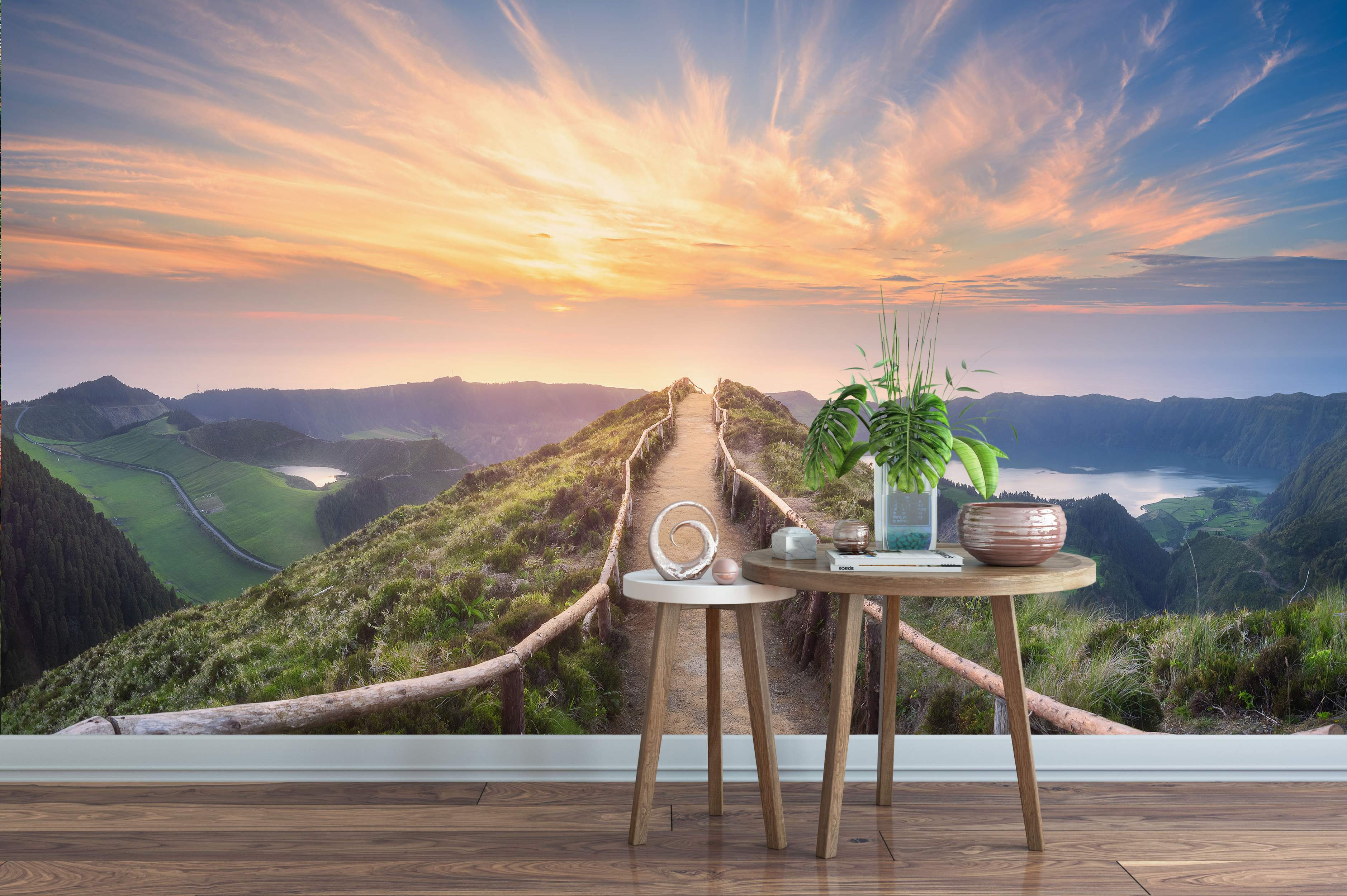 Mural depicting a scenic mountain path along a ridge overlooking lakes at sunset, with a vibrant orange and blue sky.