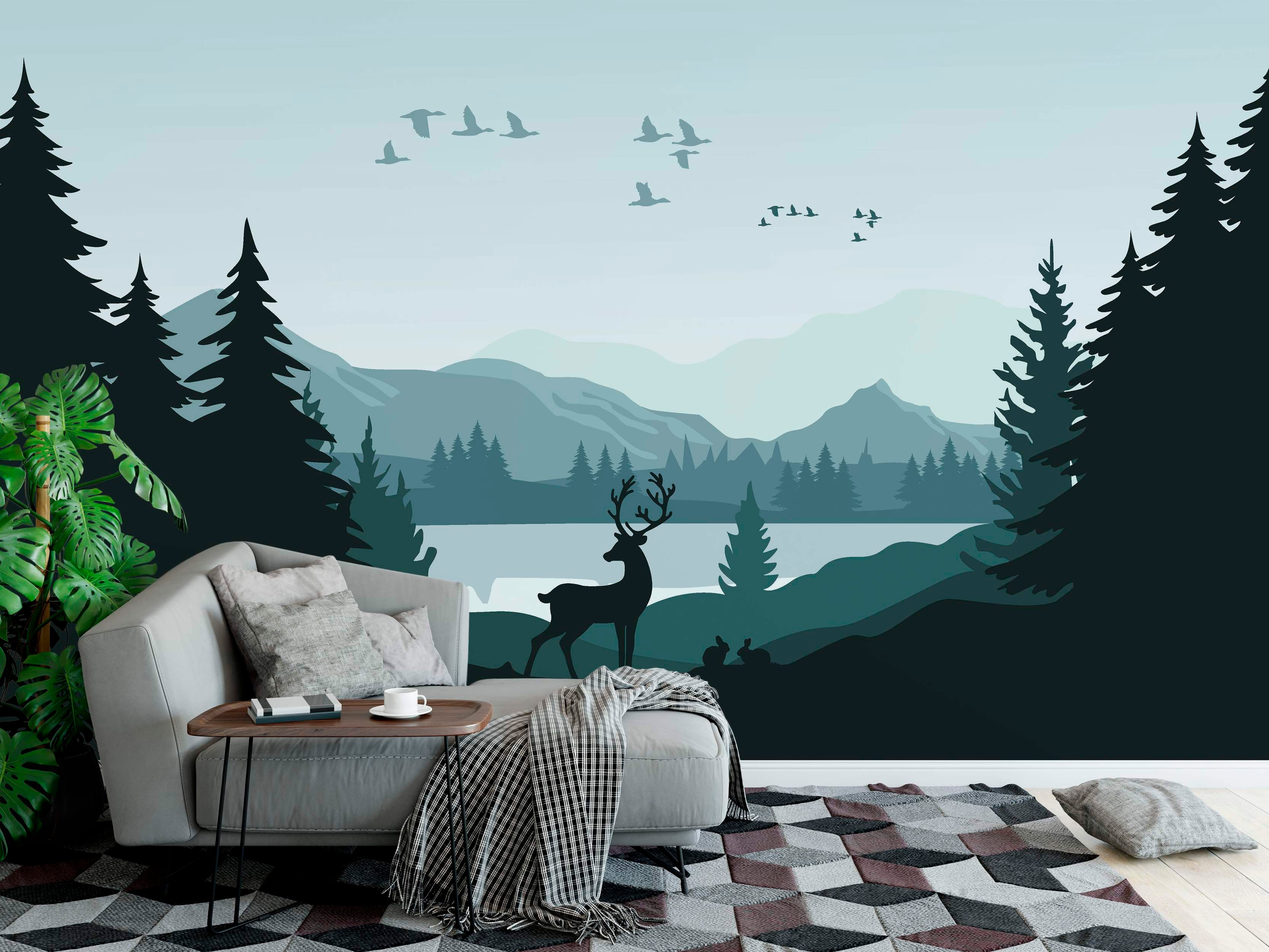 Scenic landscape mural featuring layered teal mountains, a lake, and dark silhouetted pine trees, deer, rabbits, and birds.