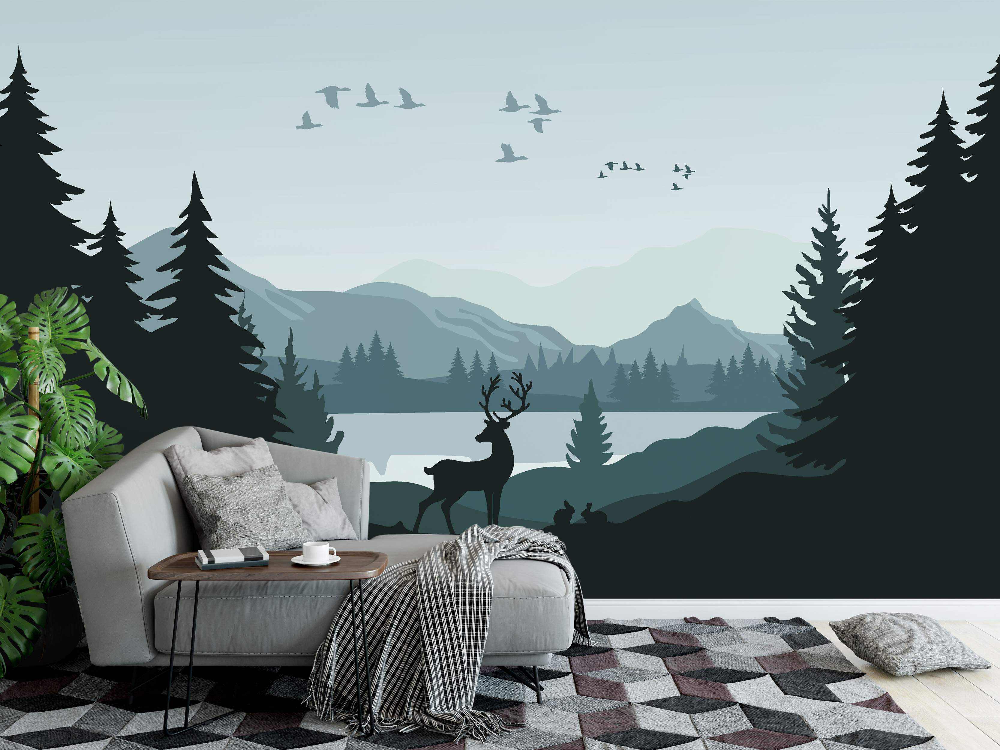 Scenic landscape mural featuring layered teal mountains, a lake, and dark silhouetted pine trees, deer, rabbits, and birds.