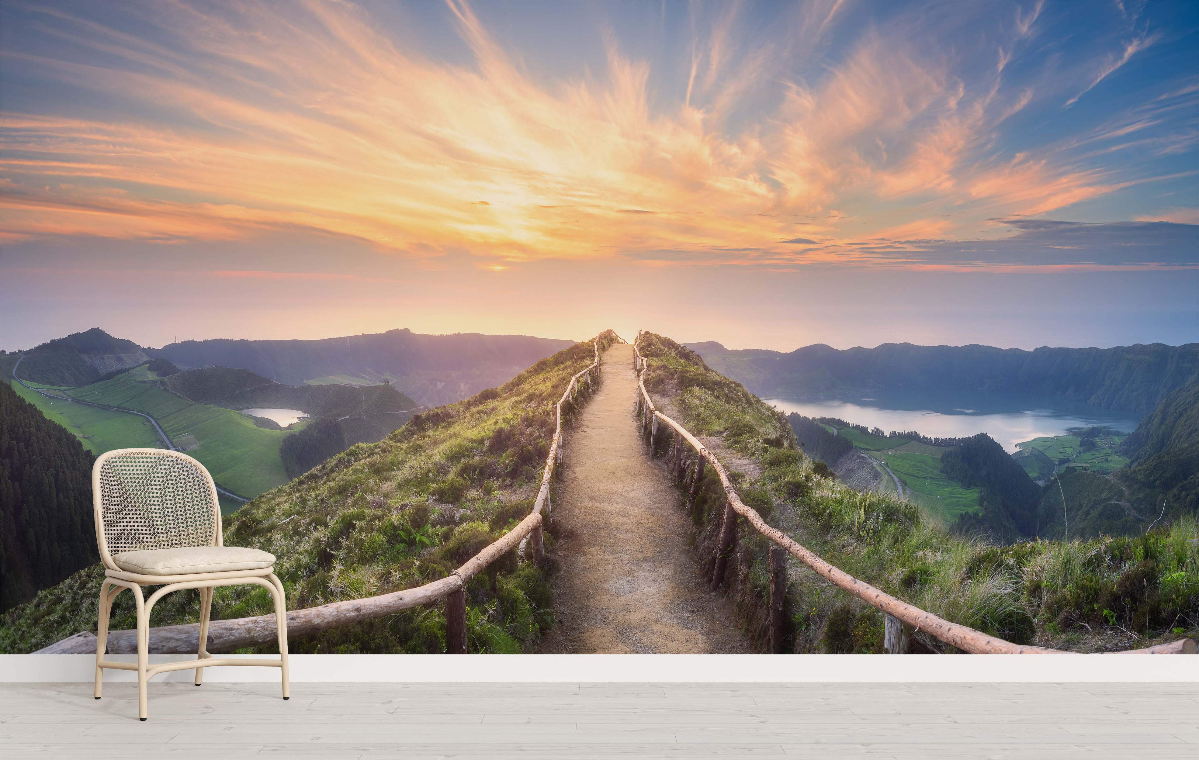 Scenic landscape mural depicting a dirt path along a ridge at sunset, overlooking lakes and green valleys below.