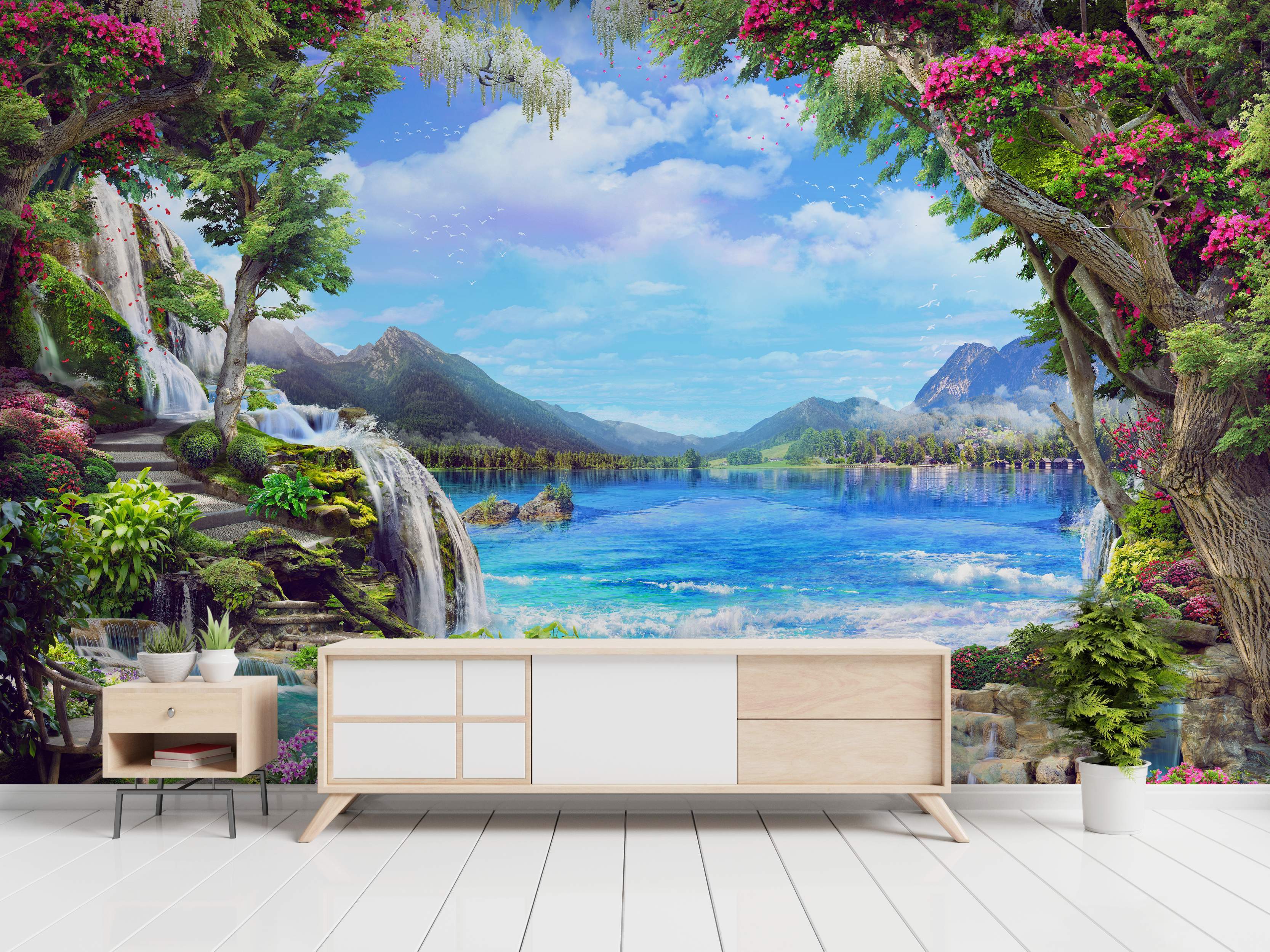 Fantasy landscape mural depicting waterfalls cascading into a bright blue lake, distant mountains, and framing trees with pink flowers.