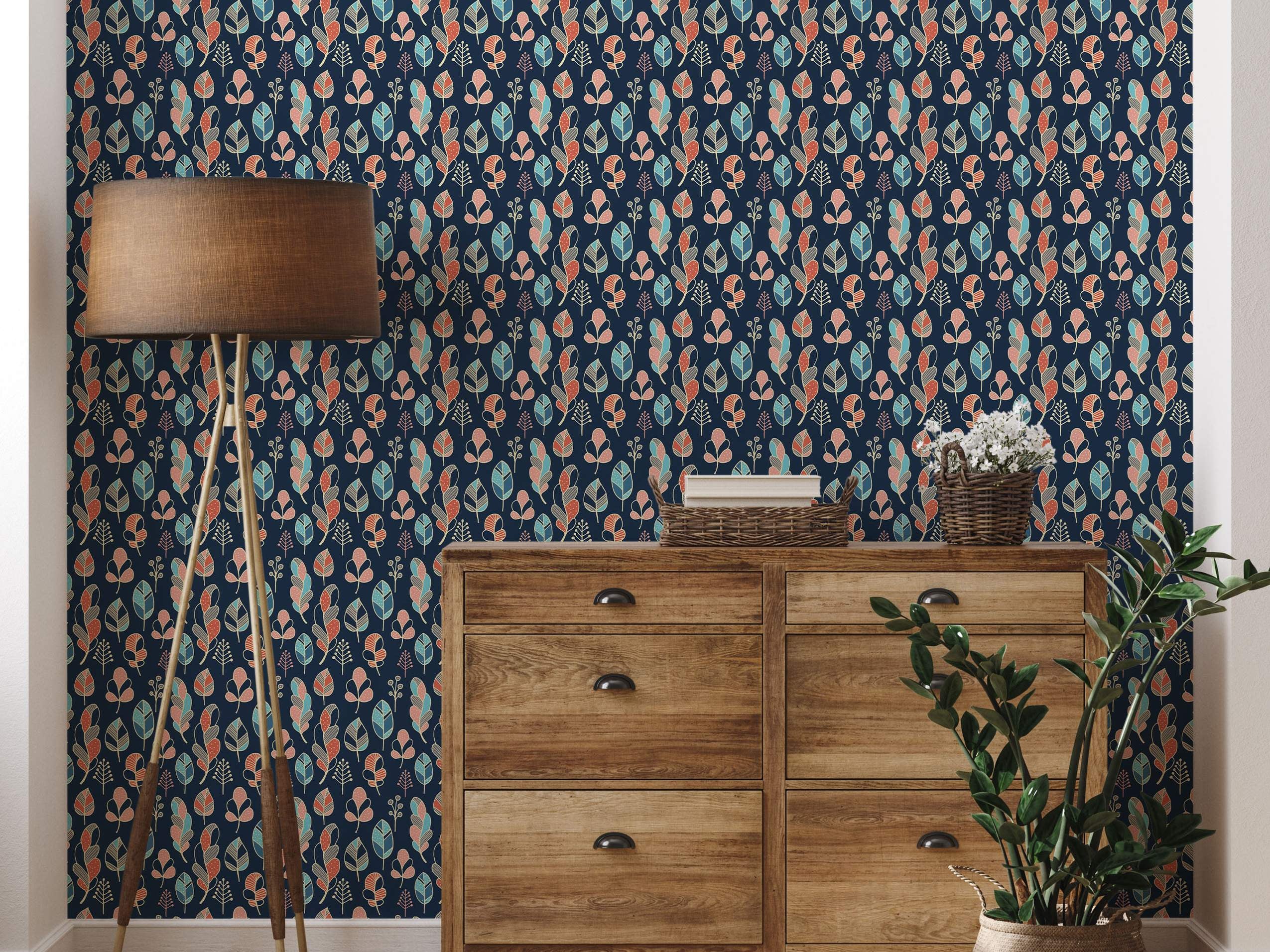 Stylized leaf and feather motif wallpaper in teal, orange, pink, and beige on a dark blue background.