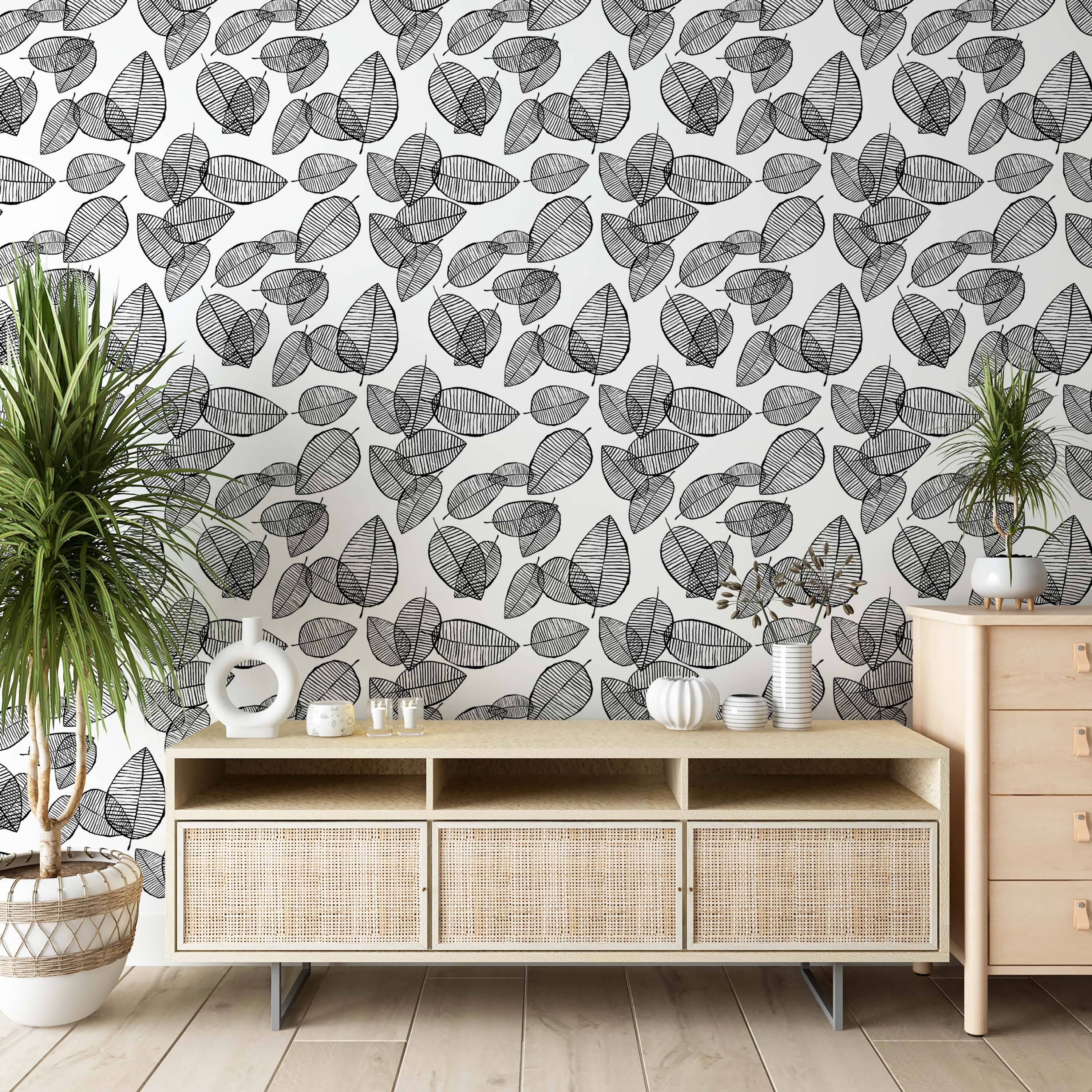 Wallpaper with a repeating pattern of stylized black leaves with horizontal line details on a white background, creating a layered effect.