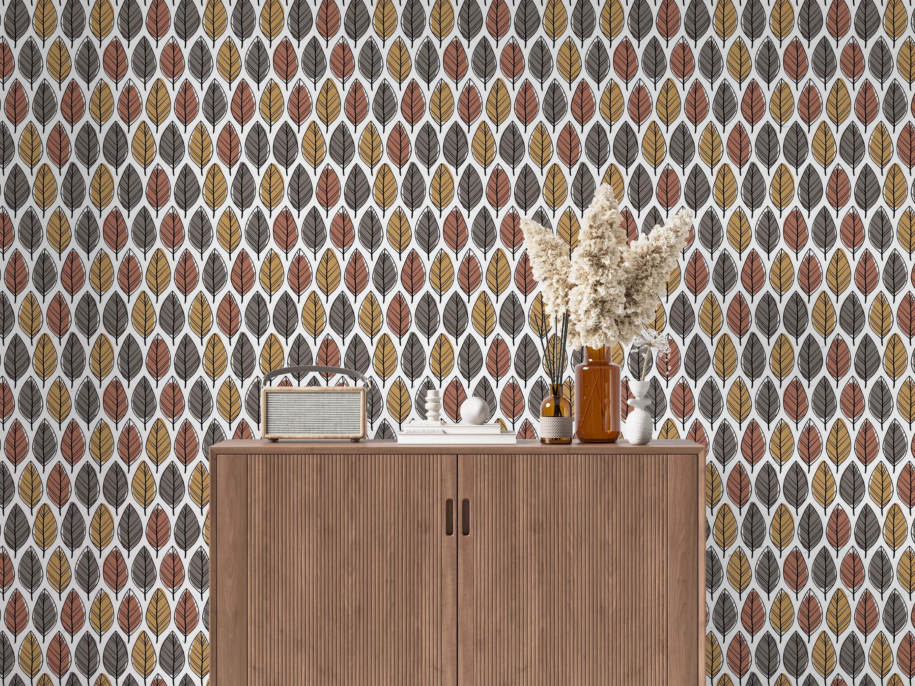 Wallpaper features a repeating pattern of stylized leaves in terracotta brown, golden yellow, and dark gray on a white background.