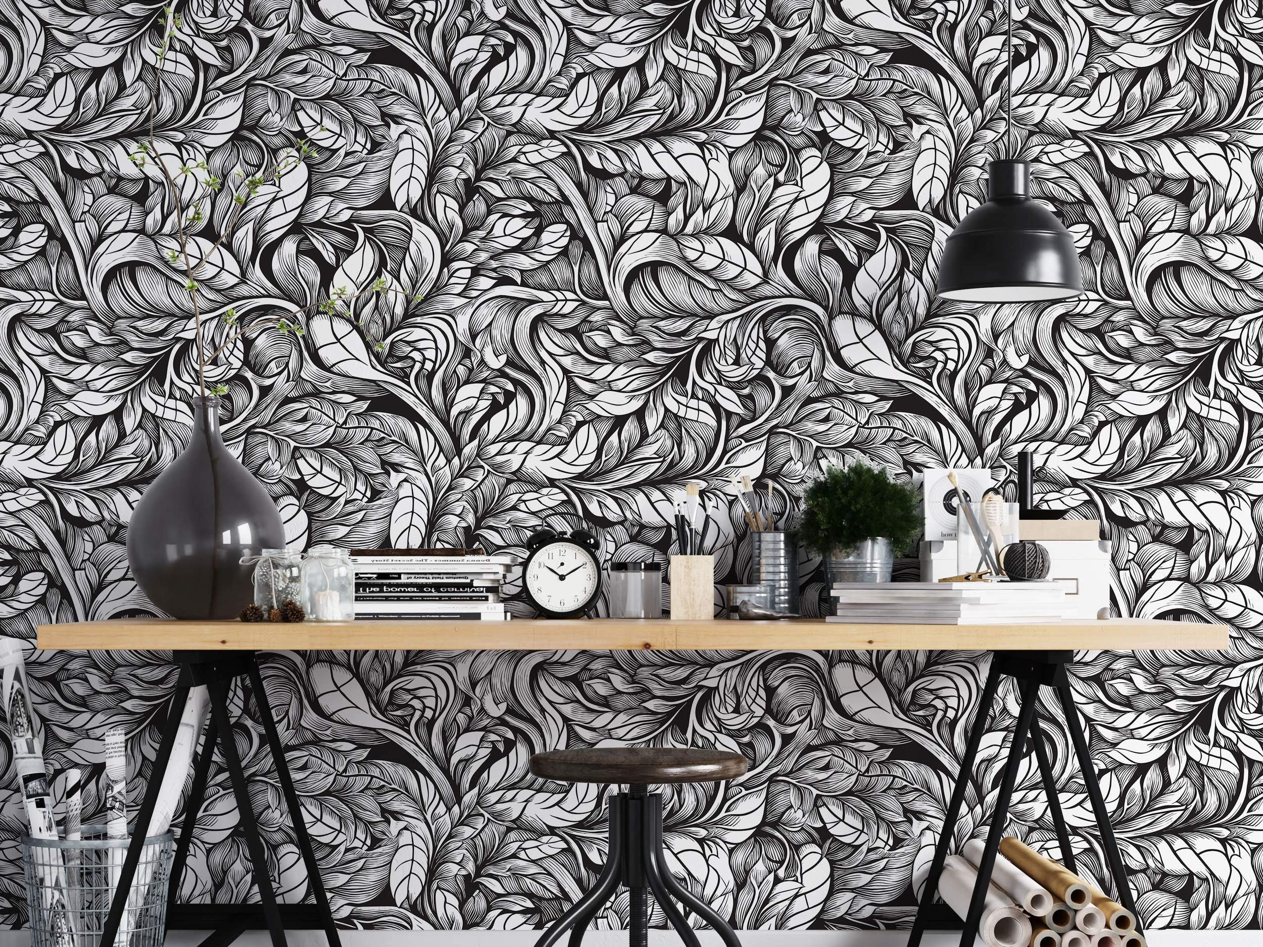 Intricate black and white wallpaper displaying a dense pattern of swirling, hand-drawn style leaves.