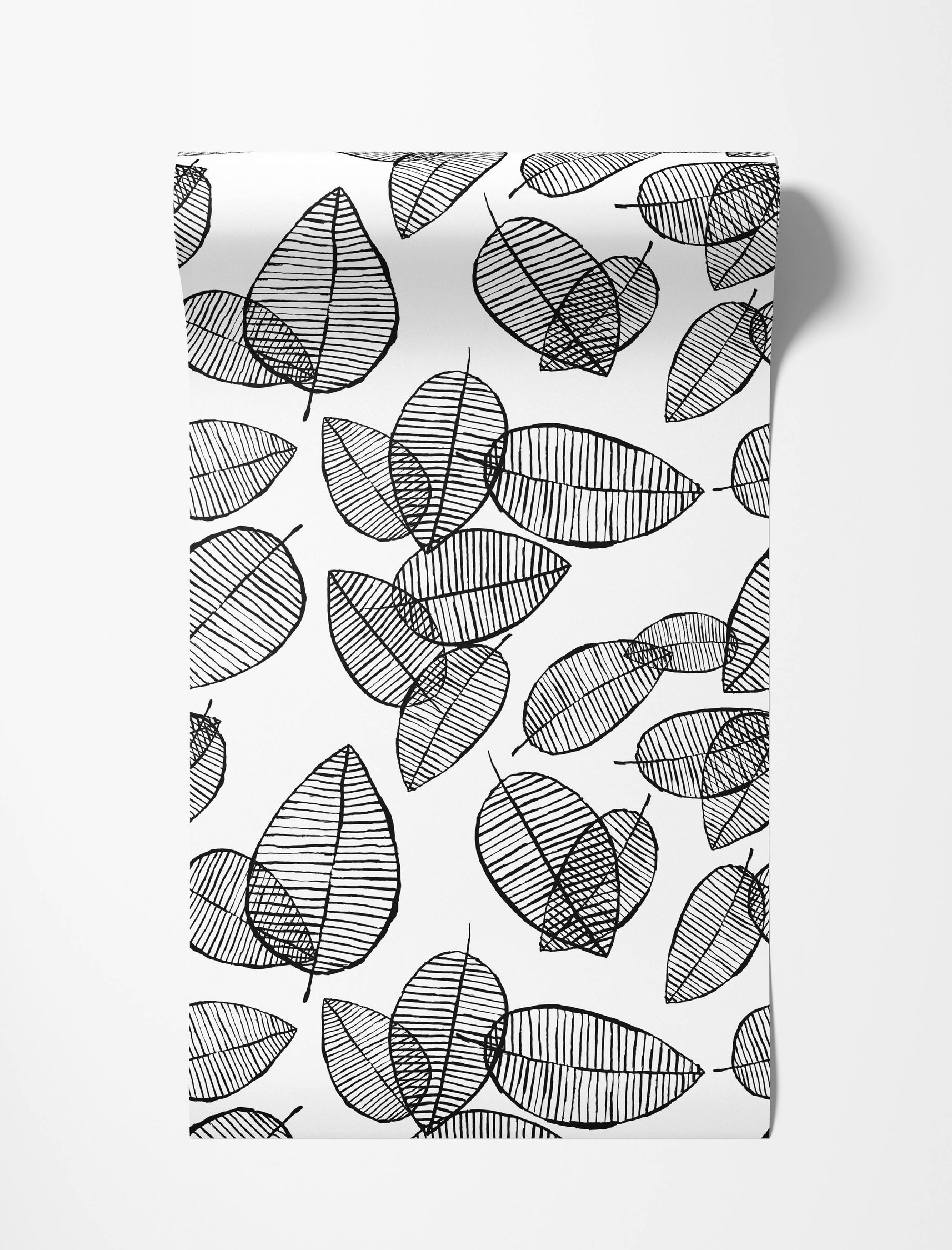 Black and white wallpaper displaying a scattered pattern of stylized leaves, each intricately filled with various black line designs.