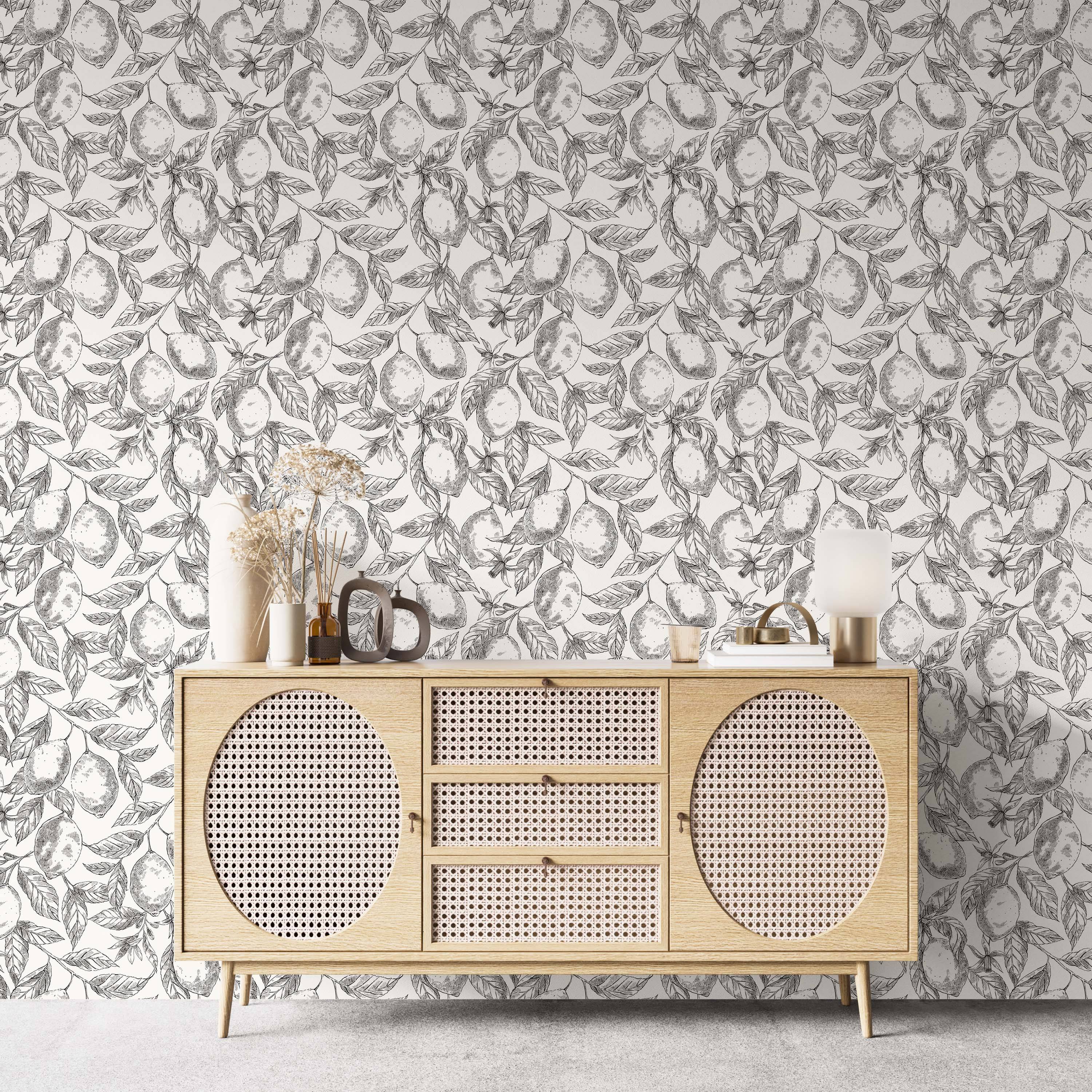 Black and white botanical wallpaper showcasing a hand-drawn sketch pattern of lemons and leaves.