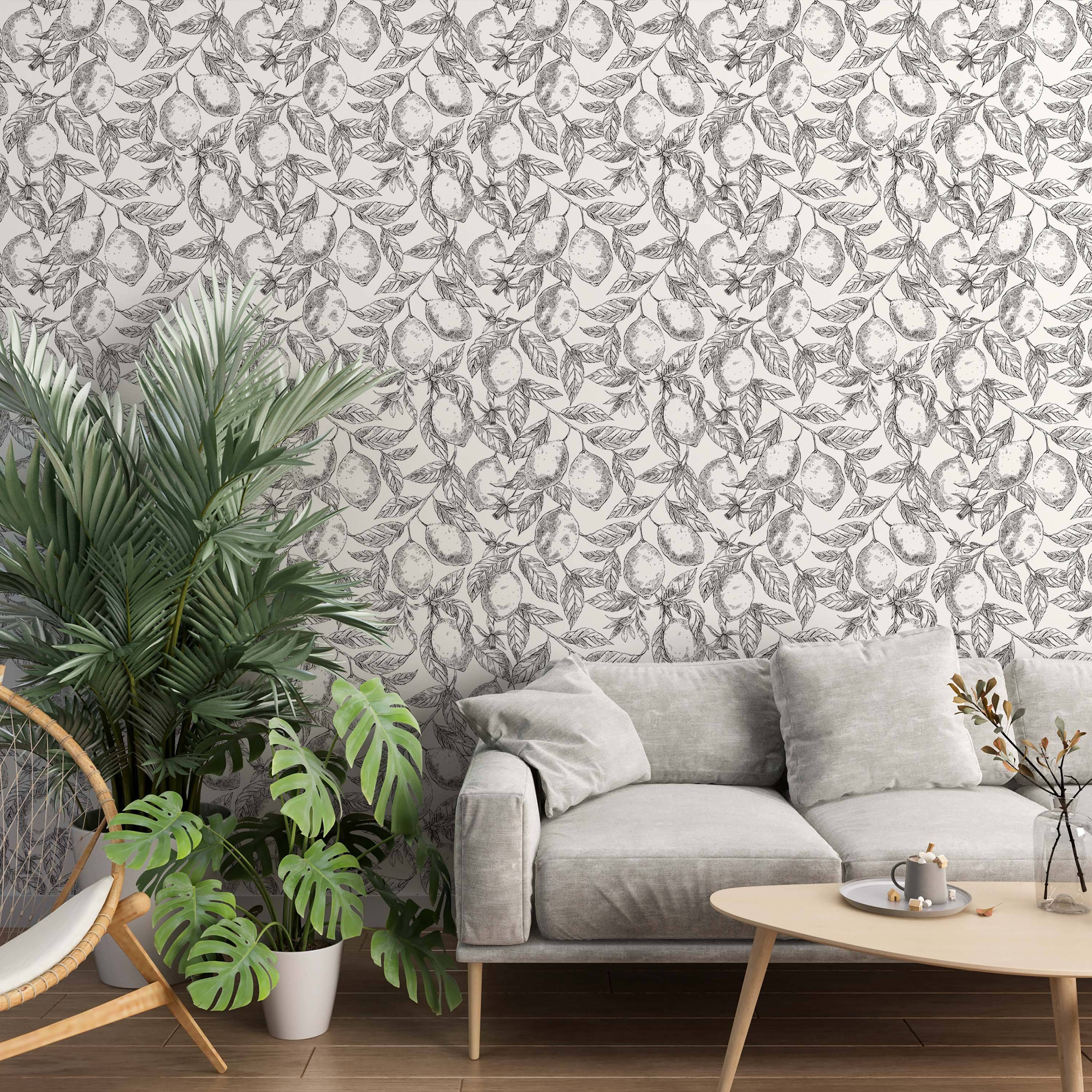 Black and white wallpaper with a detailed botanical sketch pattern of lemons, leaves, and branches.