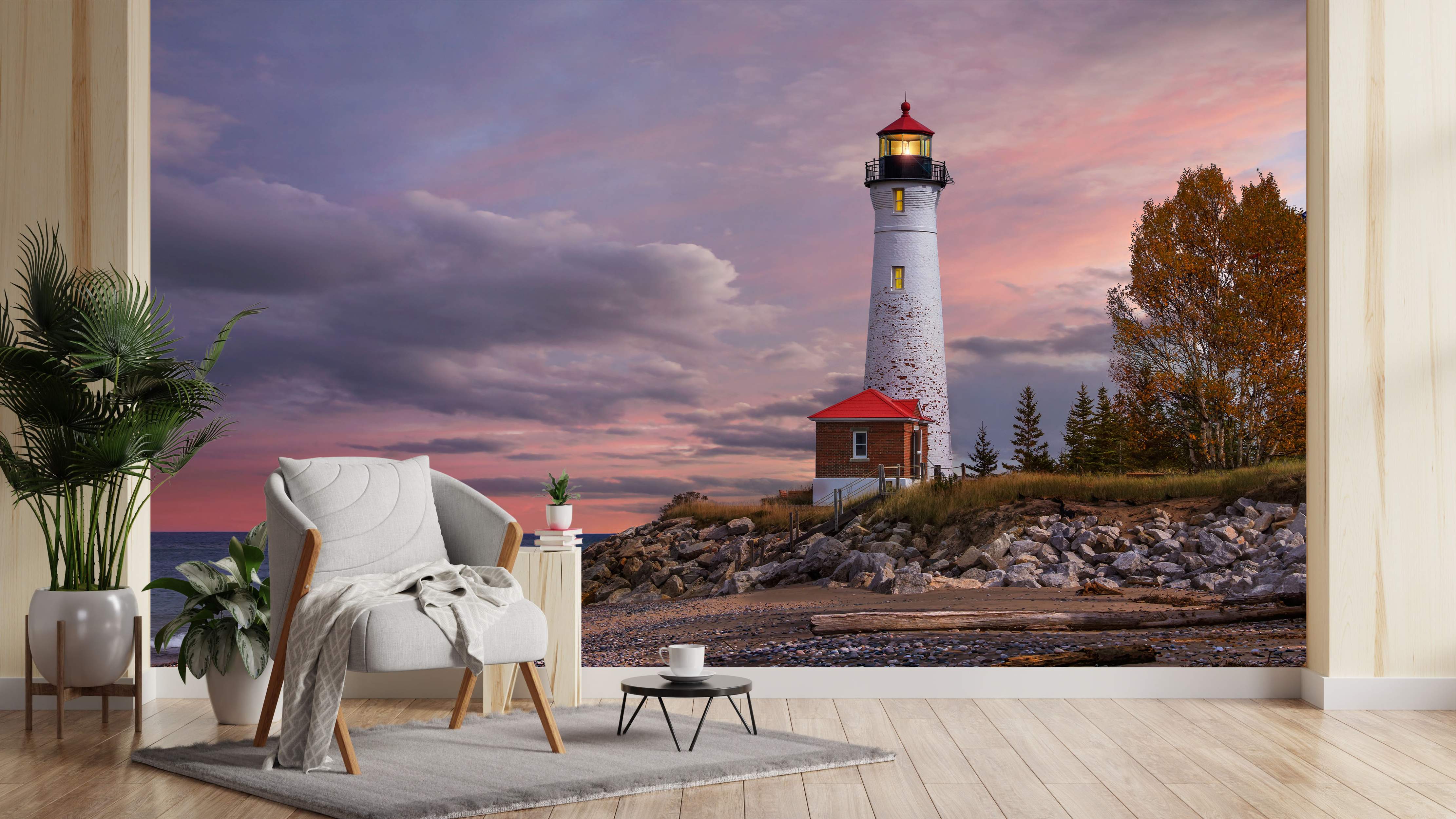 Mural featuring a white lighthouse with a red top on a rocky coast beneath a purple and pink sunset sky with clouds and trees.