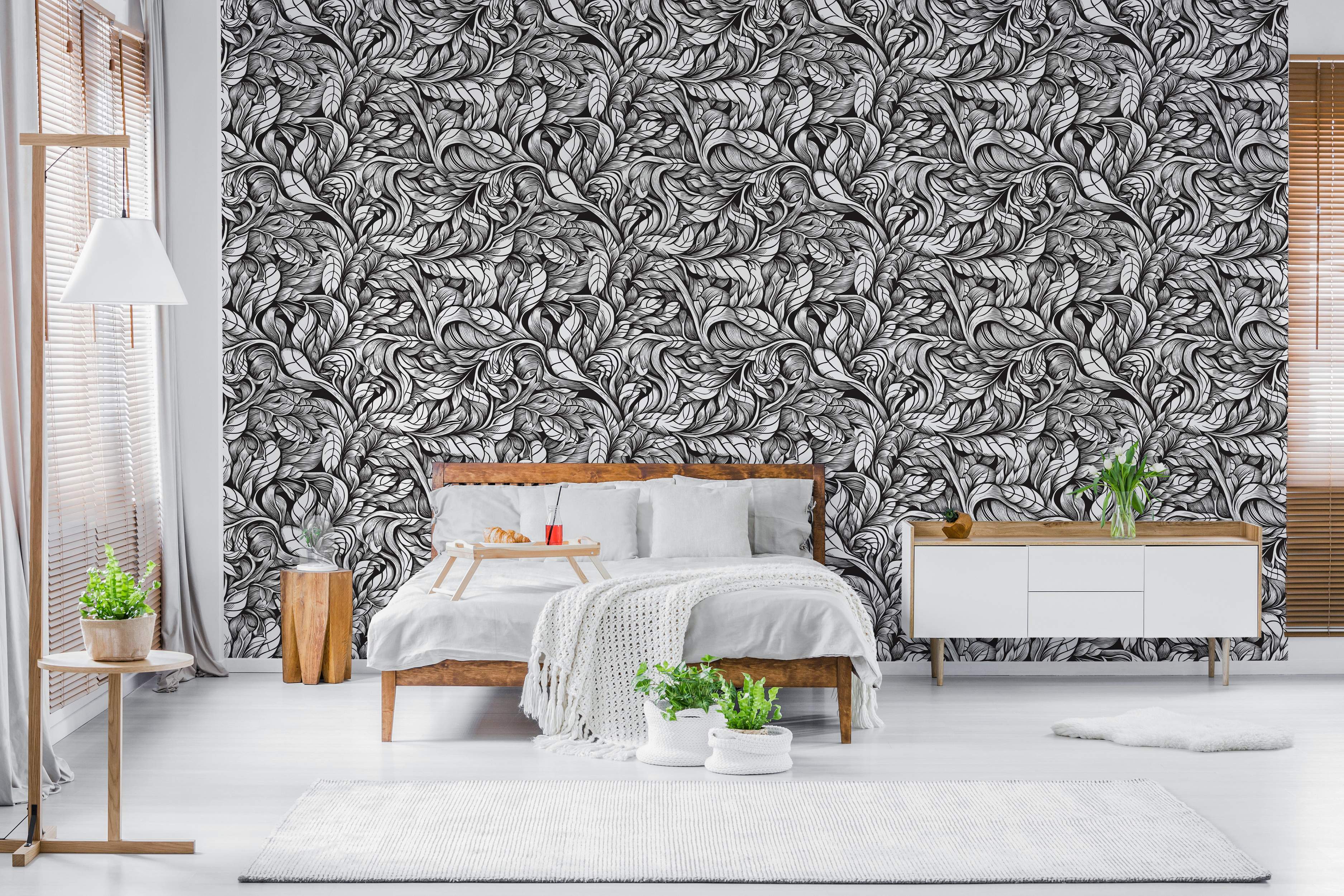 Black and white wallpaper showing complex, swirling, hand-drawn leafy patterns.