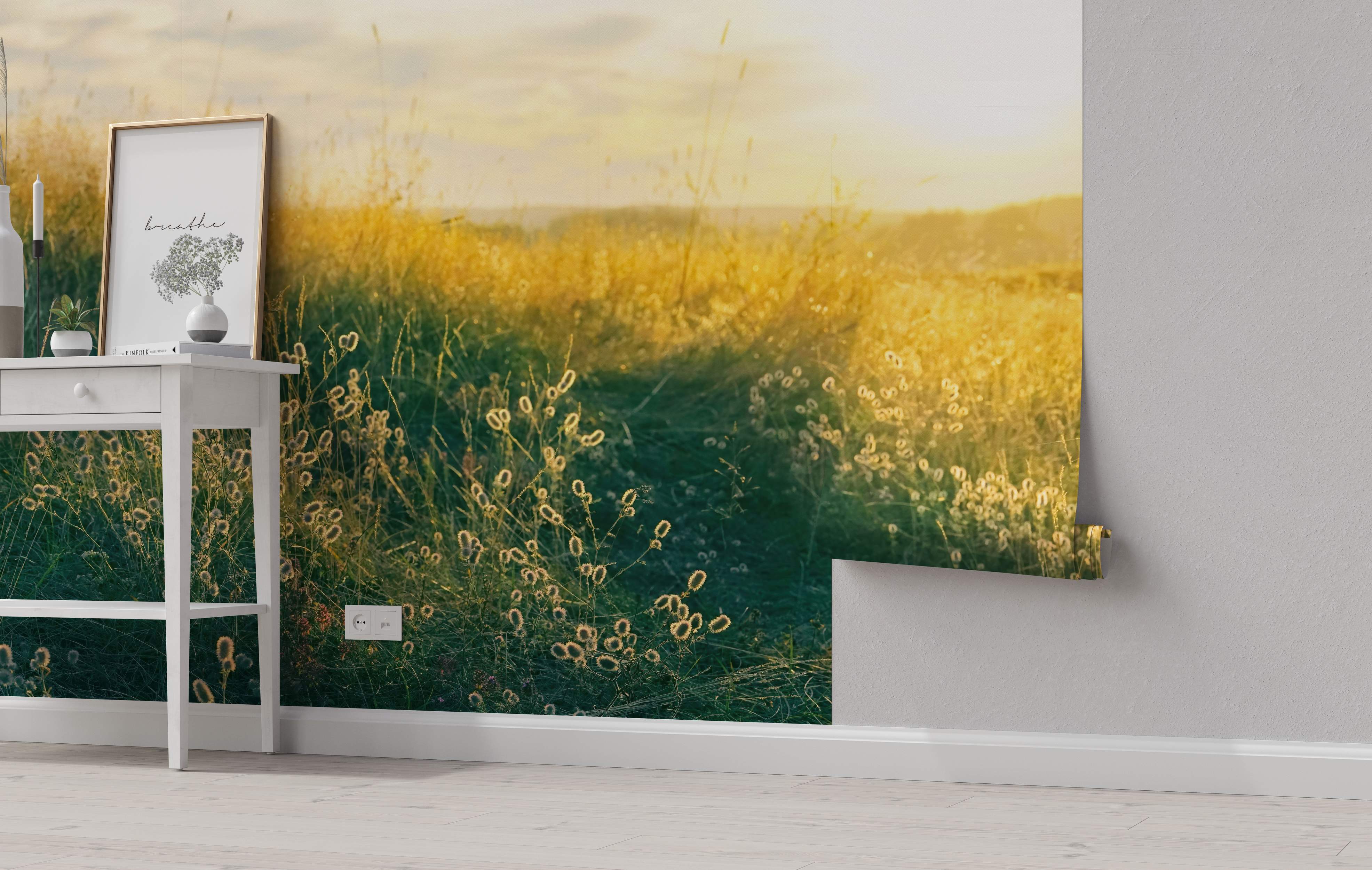 Photographic wall mural depicting a sunlit meadow with golden yellow and green grasses under a soft sky.