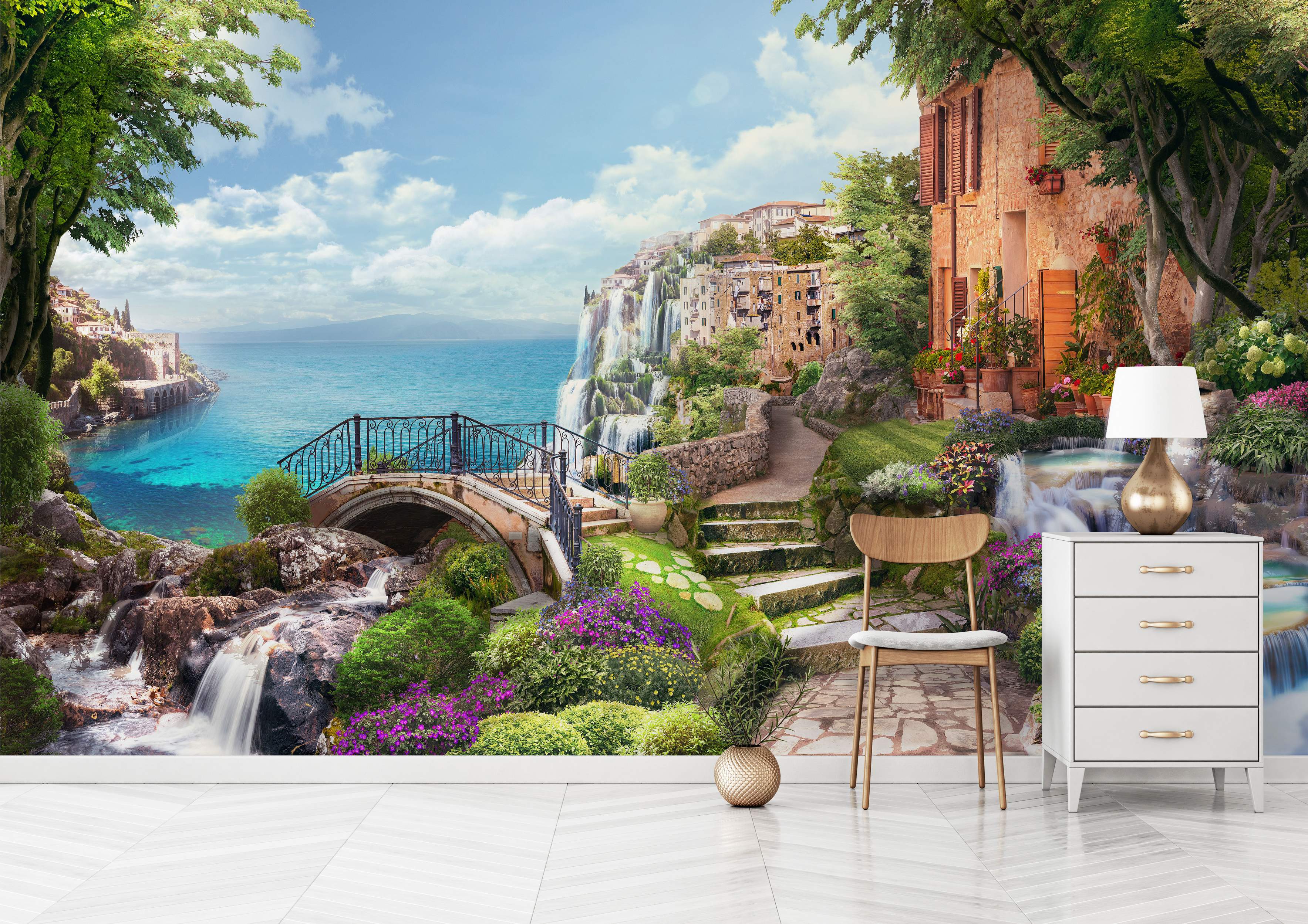 Mural depicting a scenic Mediterranean coastal village with waterfalls, stone buildings, a bridge, lush greenery, and blue sea.