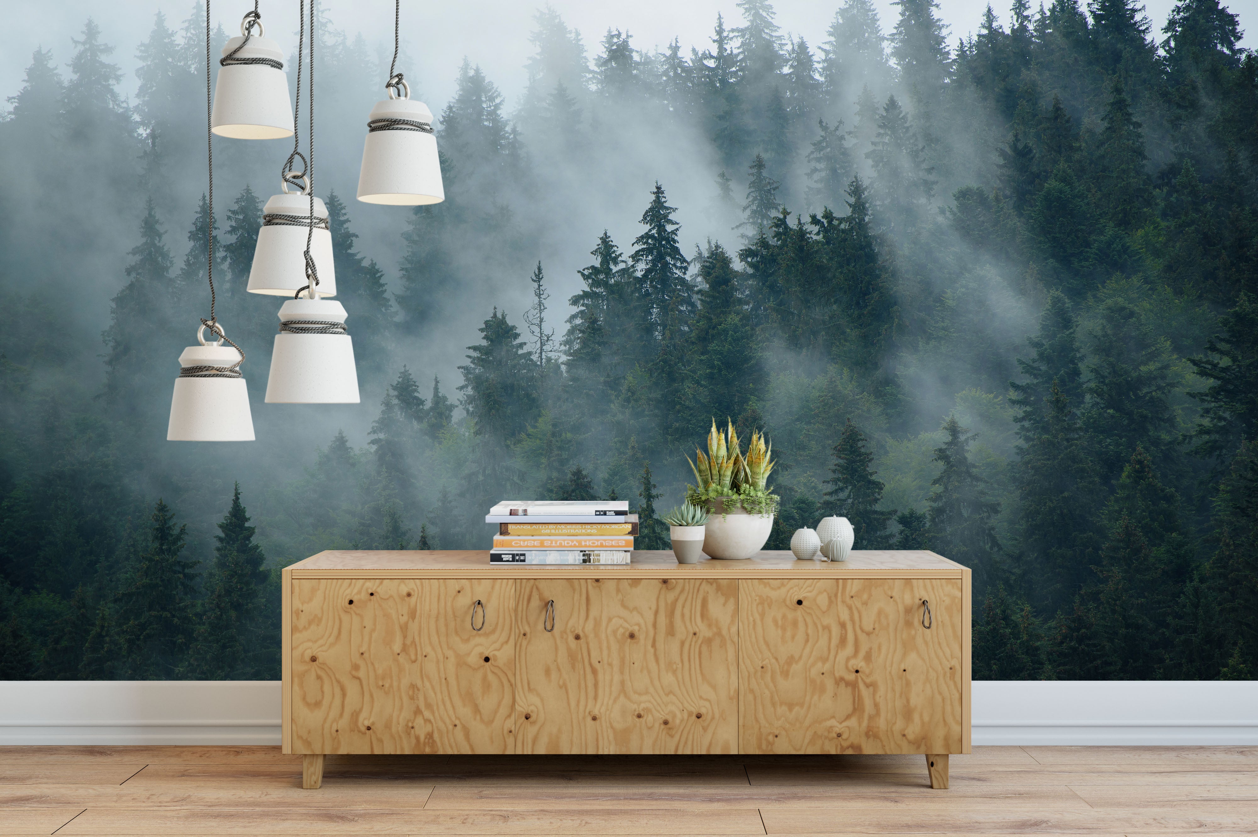 Scenic mural depicting tall green pine trees emerging through dense gray mountain mist.