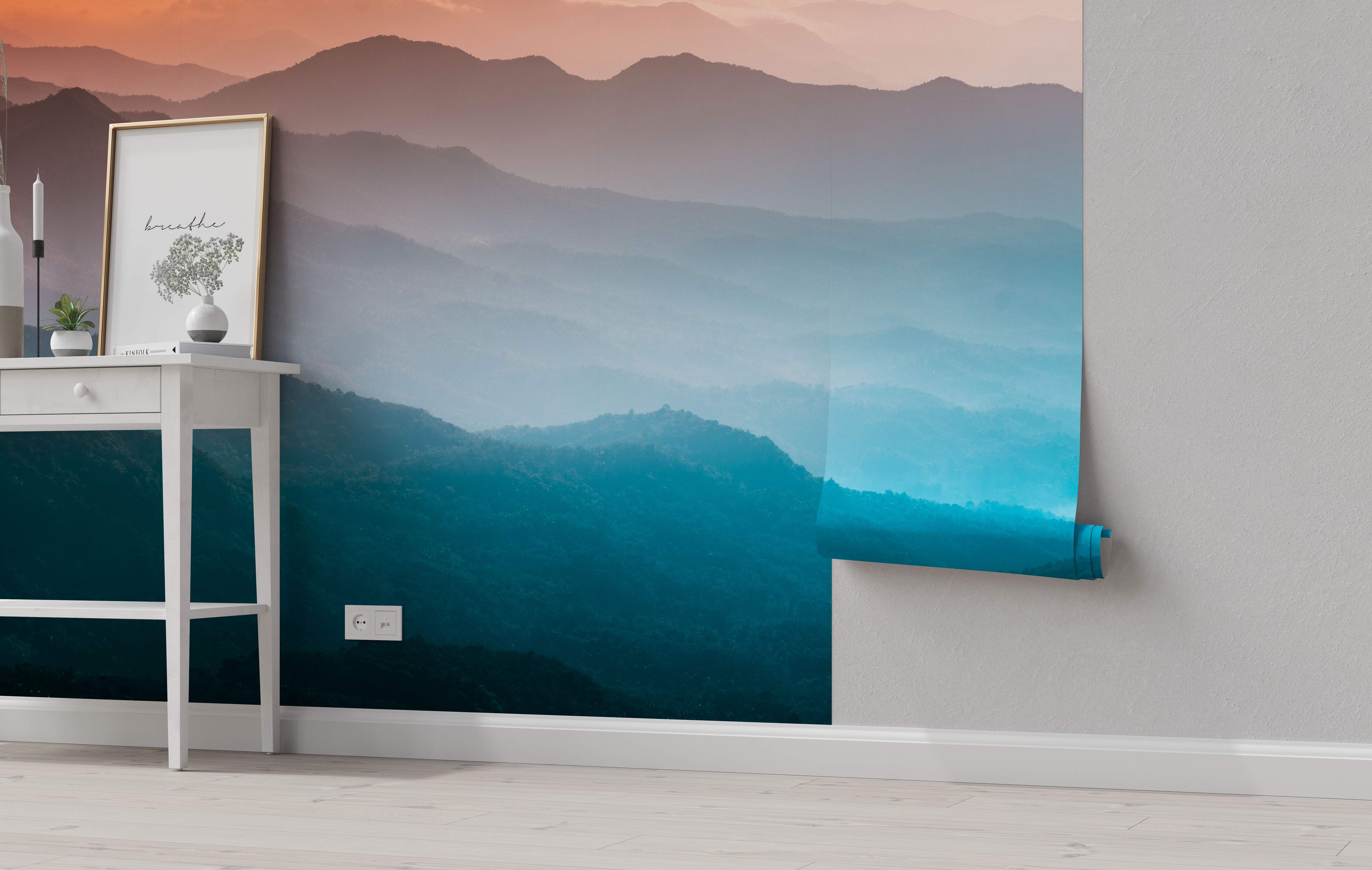 Mural depicting hazy mountain ranges with a color gradient from warm orange/pink sky to deep teal blue foreground.