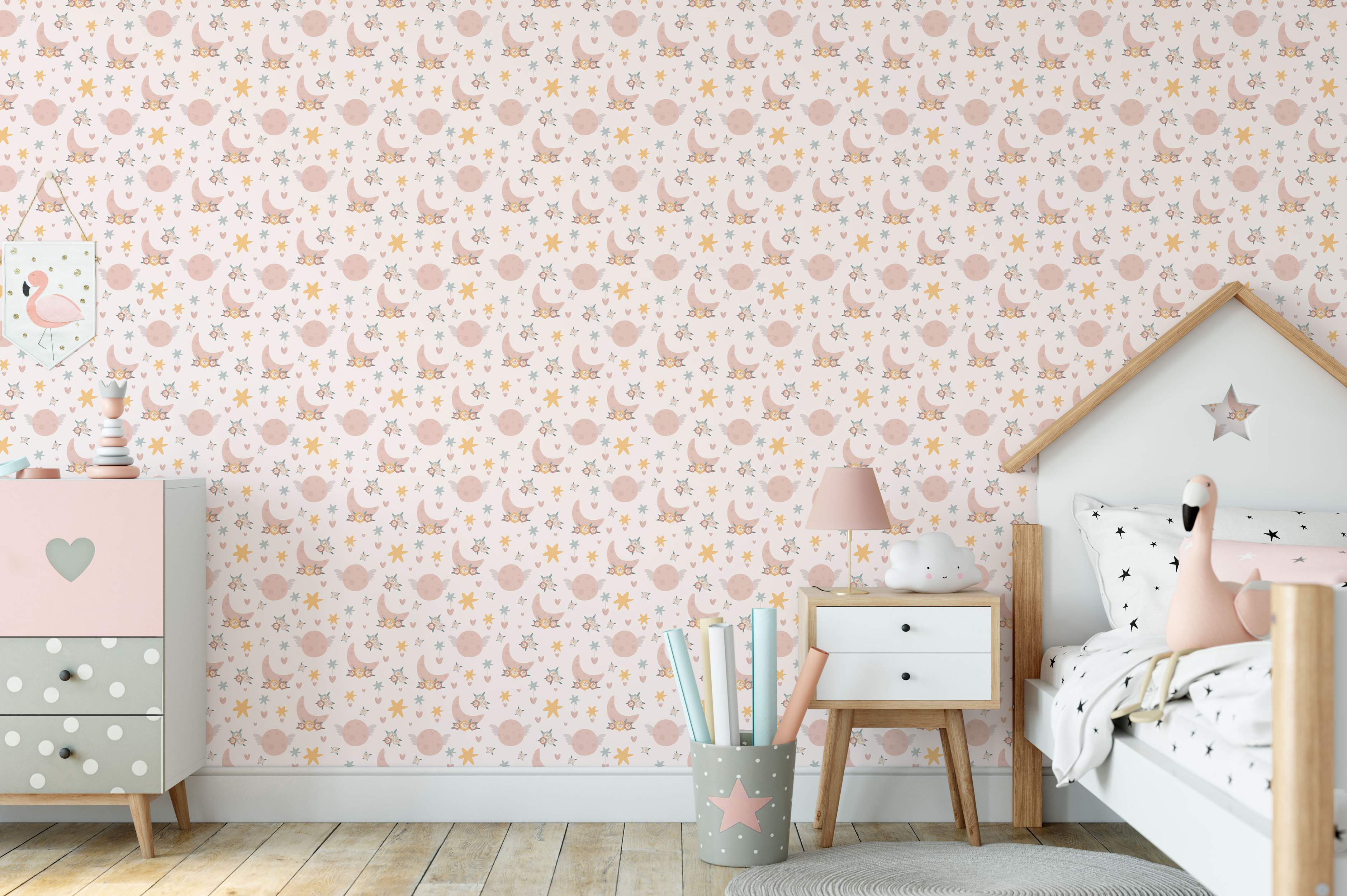 Kids wallpaper with pink floral moons, winged planets, yellow stars, blue stars, and hearts on a pale background.