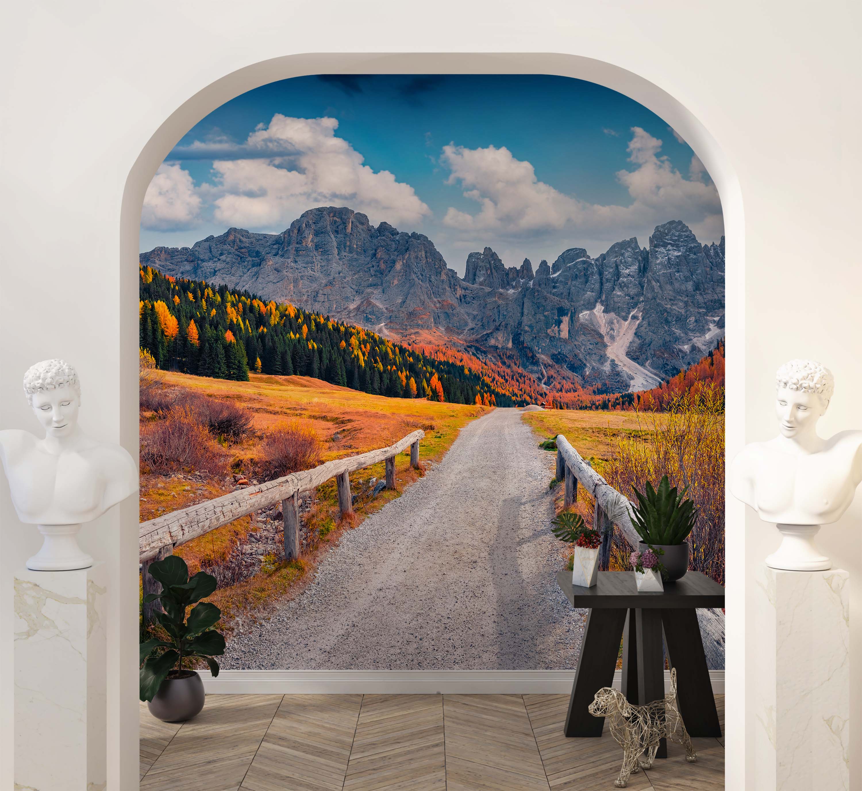 A photorealistic mural of a winding road through a mountain valley in autumn, with orange and yellow trees and rocky peaks.