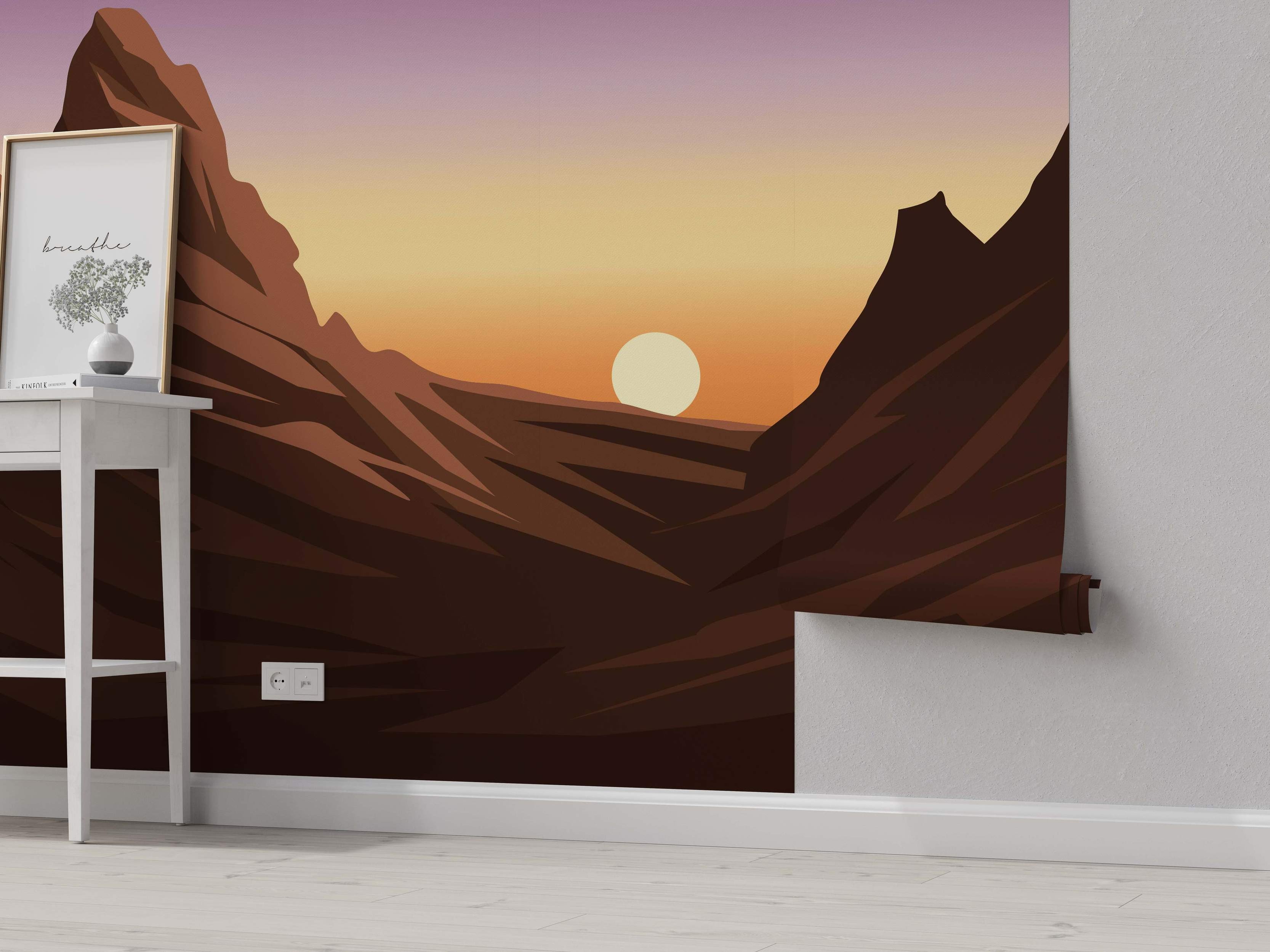 Mural depicting a stylized canyon landscape at sunset with angular brown mountains and a purple-to-orange gradient sky.