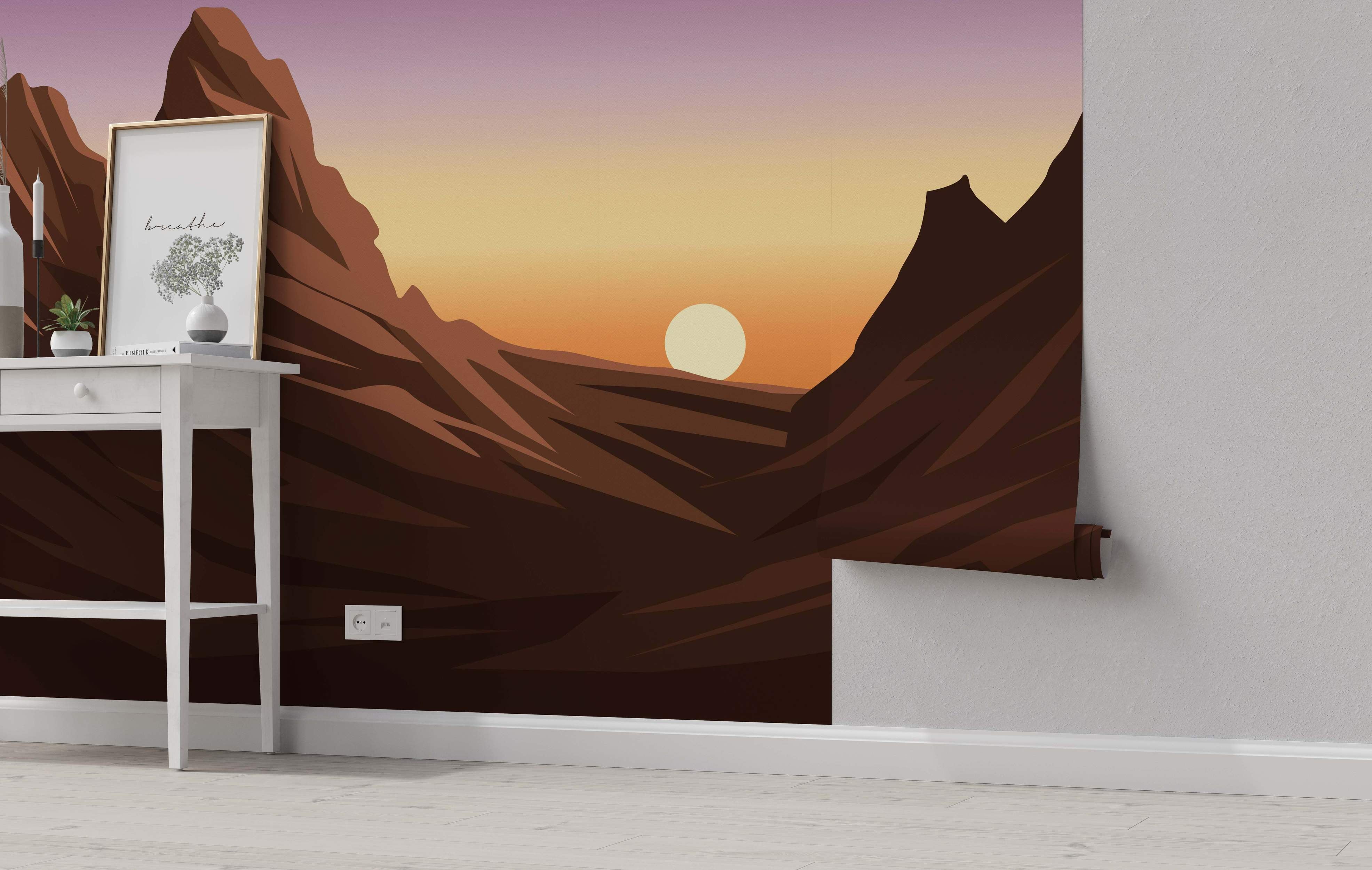 Mural depicting a stylized canyon landscape at sunset with angular brown mountains and a purple-to-orange gradient sky.
