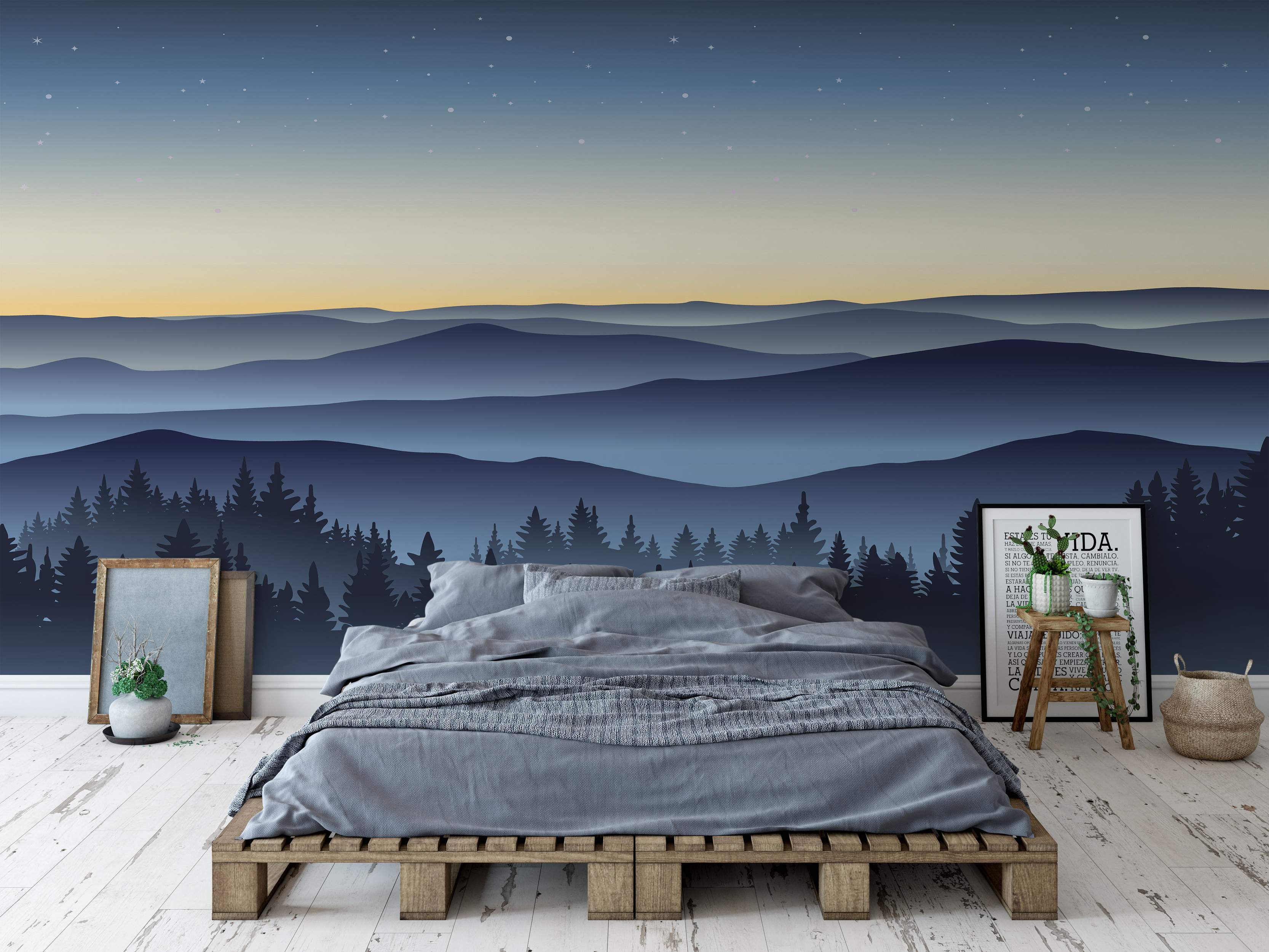 Mural featuring layered blue mountains under a gradient orange-to-blue starry sky, with a dark forest silhouette in the foreground.