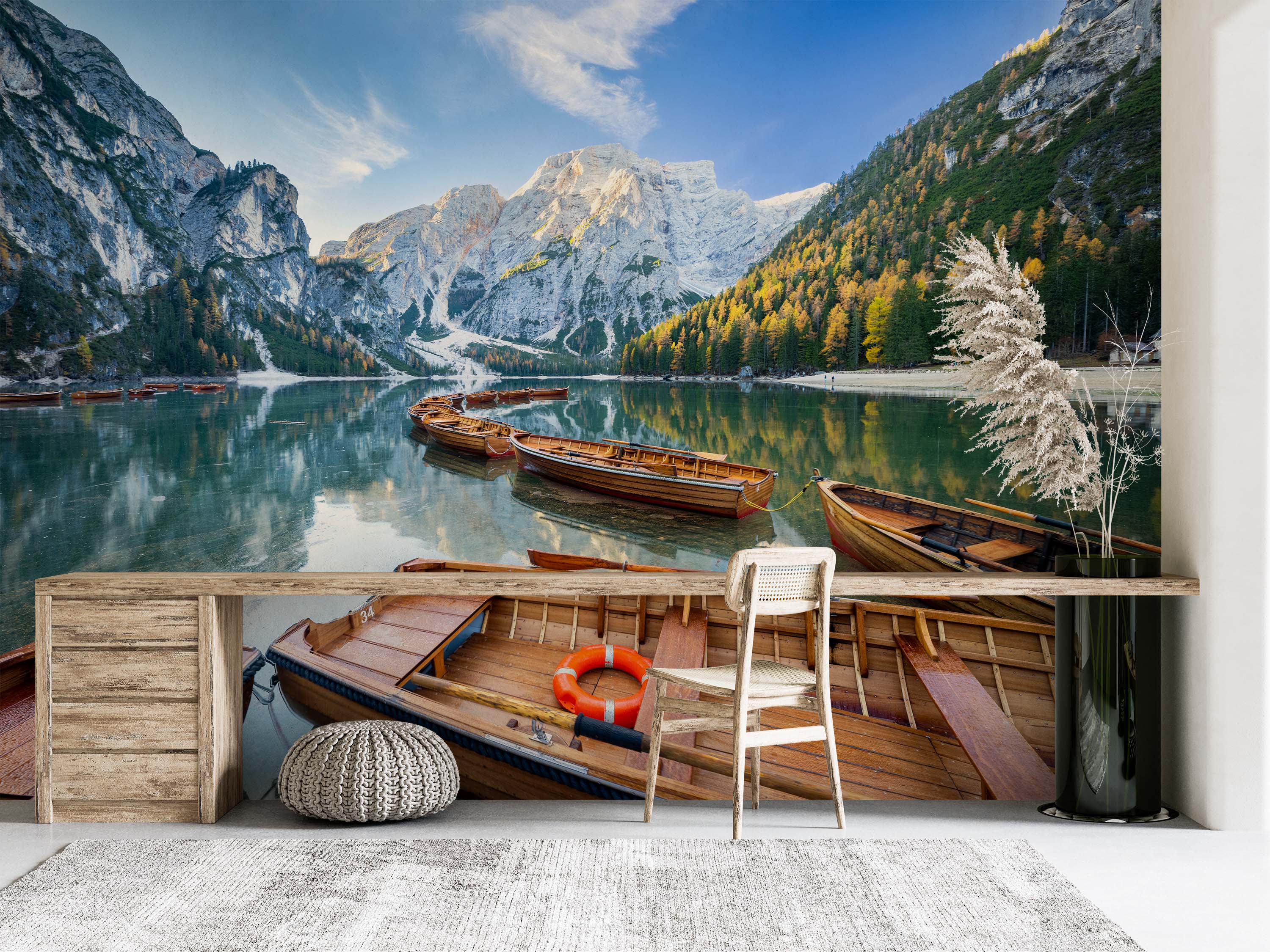 A photorealistic mural of wooden boats on a calm alpine lake, with snow-capped mountains and autumn forests in the background.