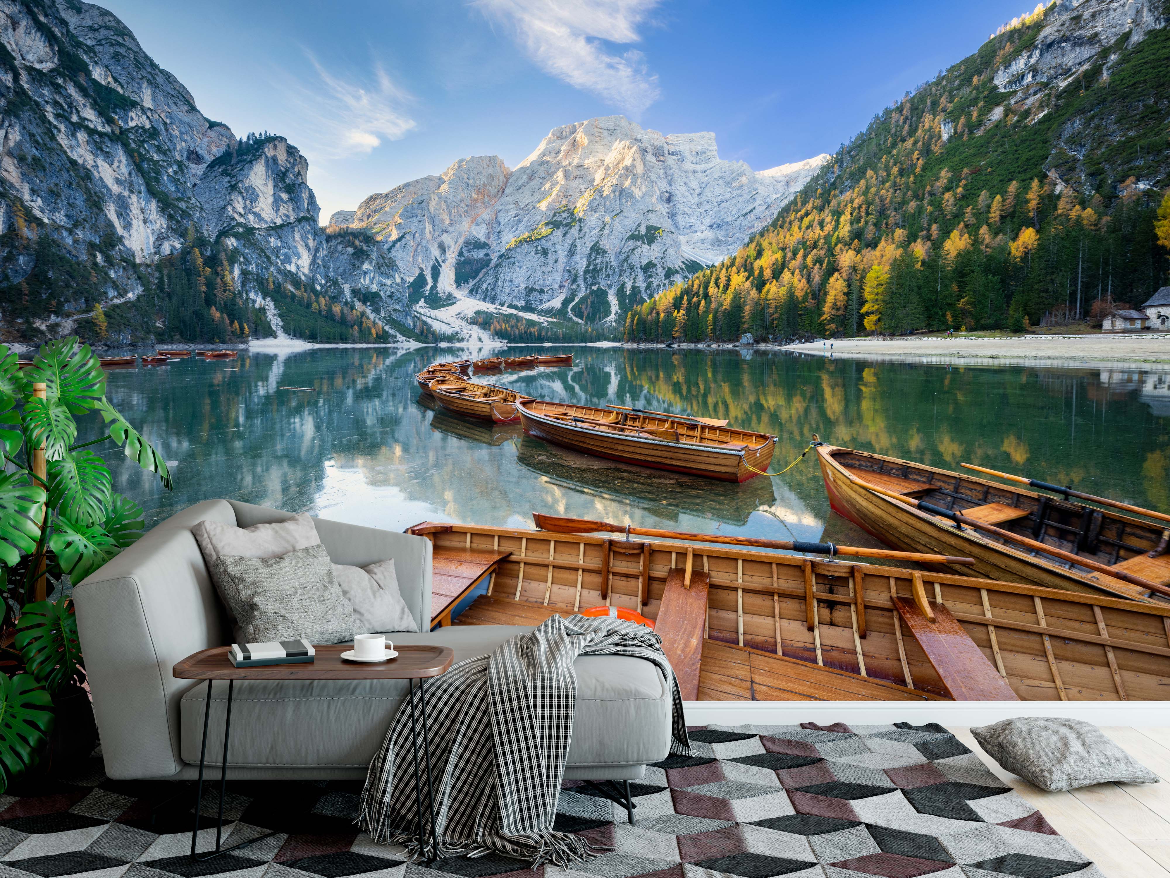 Photorealistic mural of wooden rowboats on a tranquil alpine lake, surrounded by autumn forests and sunlit rocky mountains.