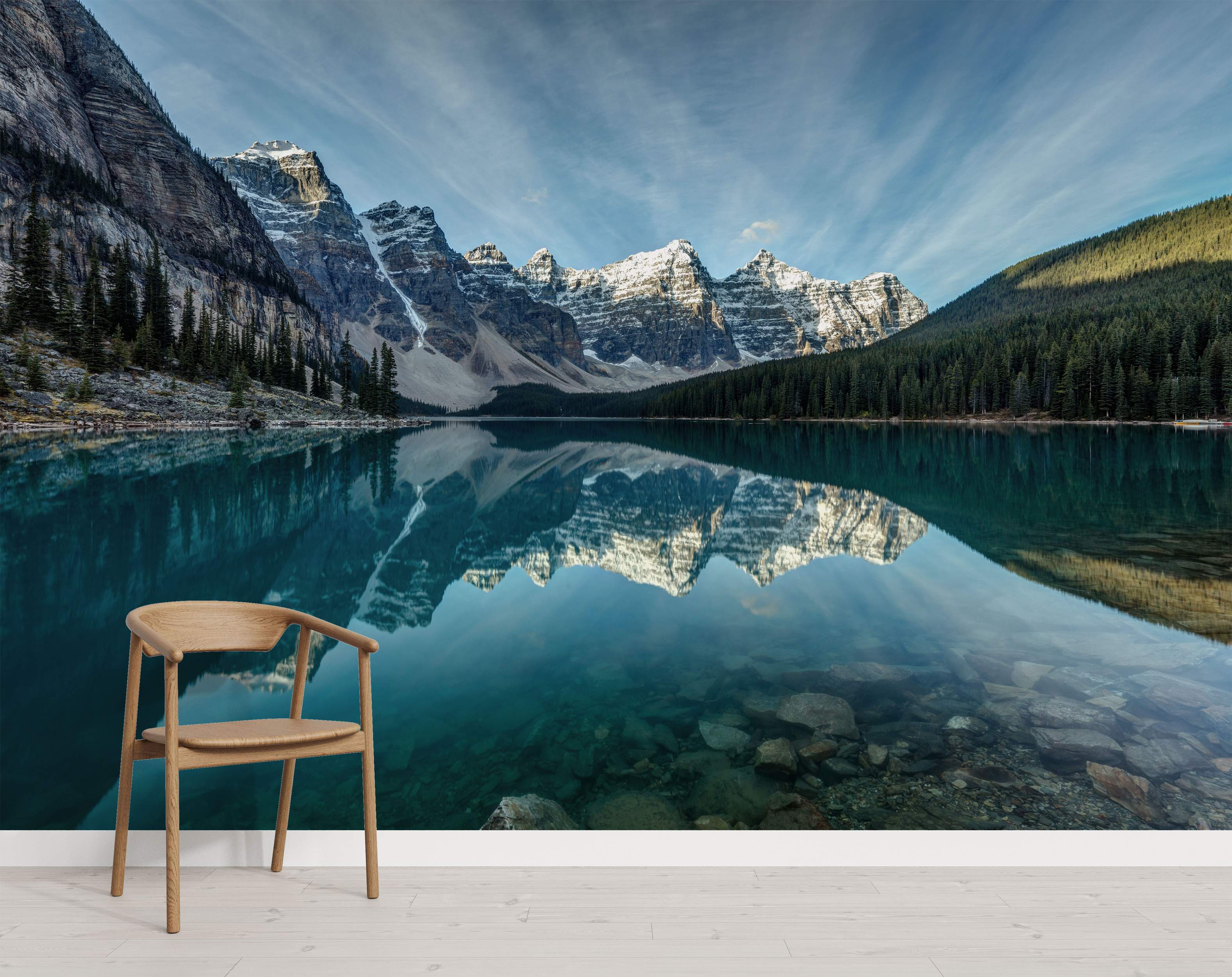 Photographic mural depicting snow-capped mountains reflecting in a clear turquoise lake with surrounding pine forests under a blue sky.