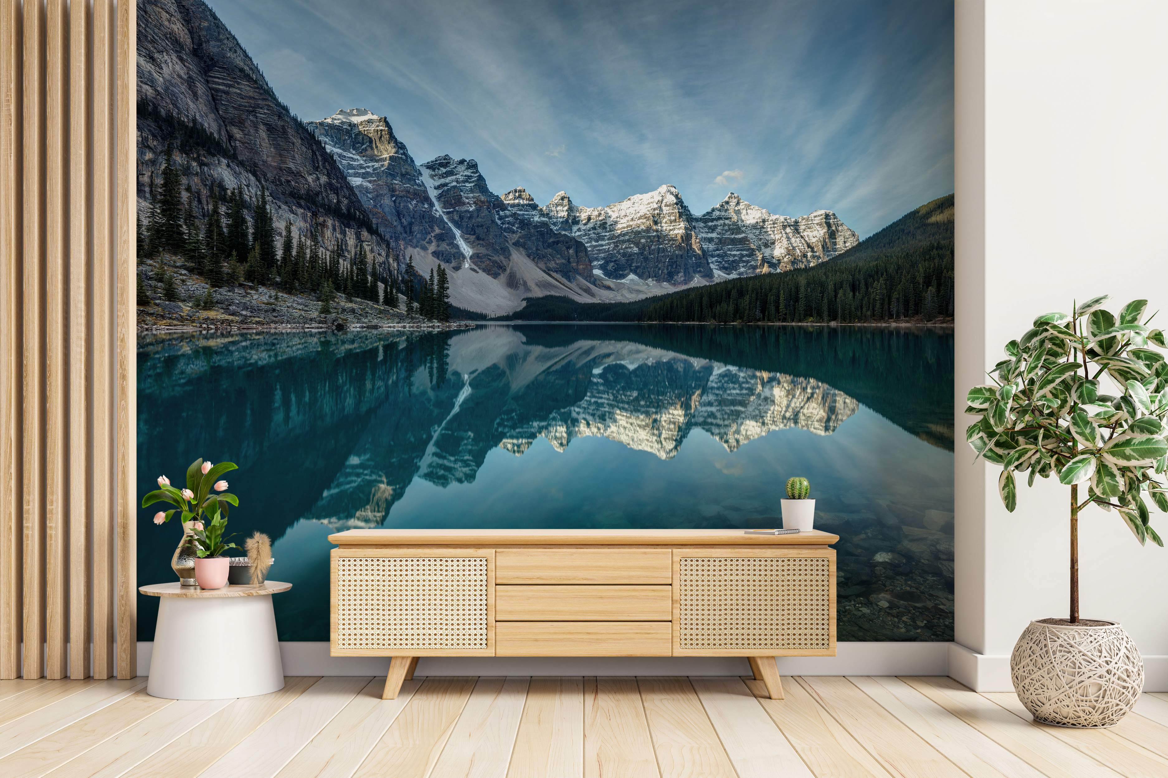 Photorealistic mural of snow-capped mountains and pine forests perfectly reflected in a calm, turquoise lake under a blue sky.