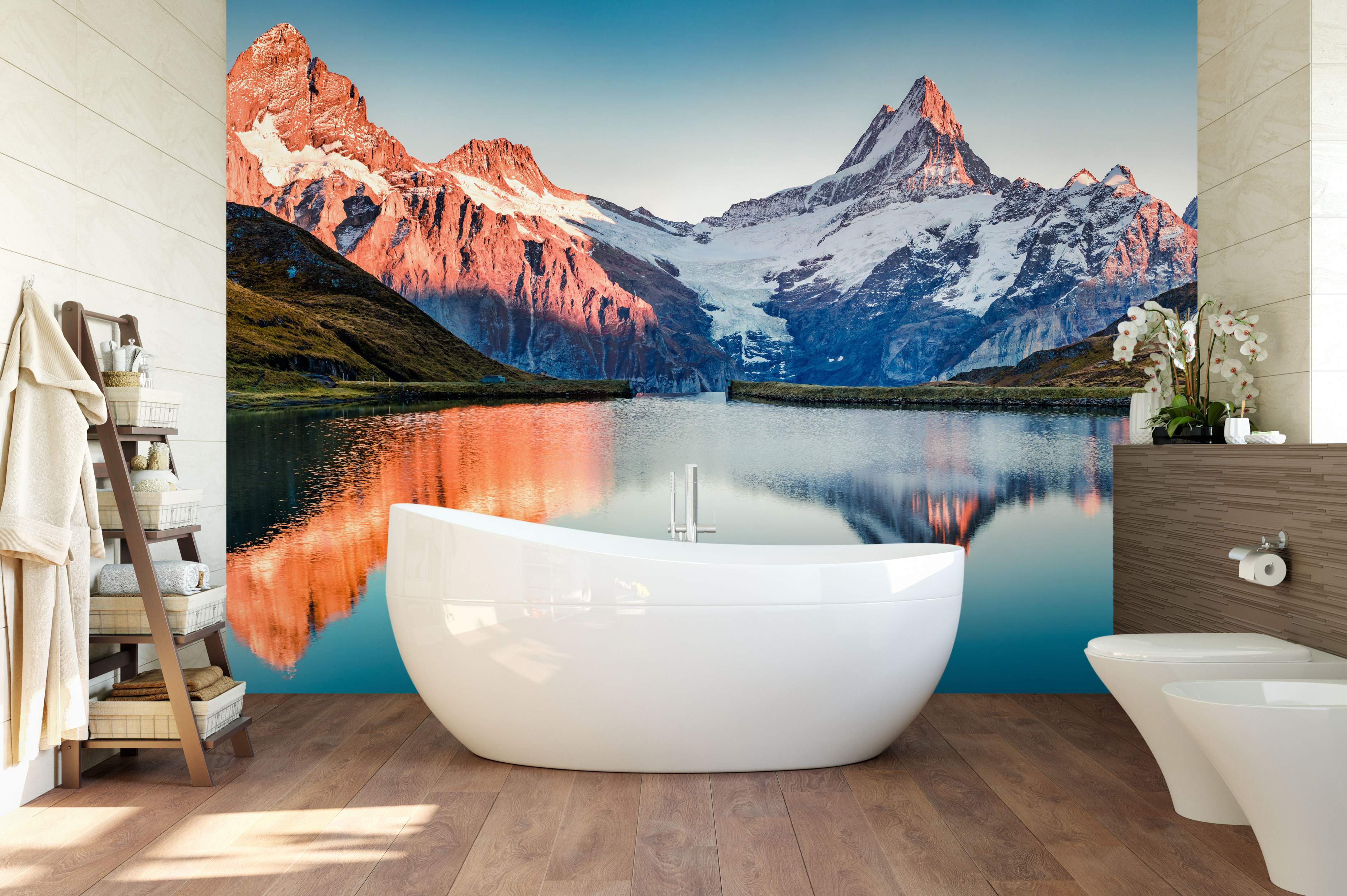 Scenic mountain mural with snow-capped peaks glowing orange at sunset, reflecting in a calm blue lake below clear skies.