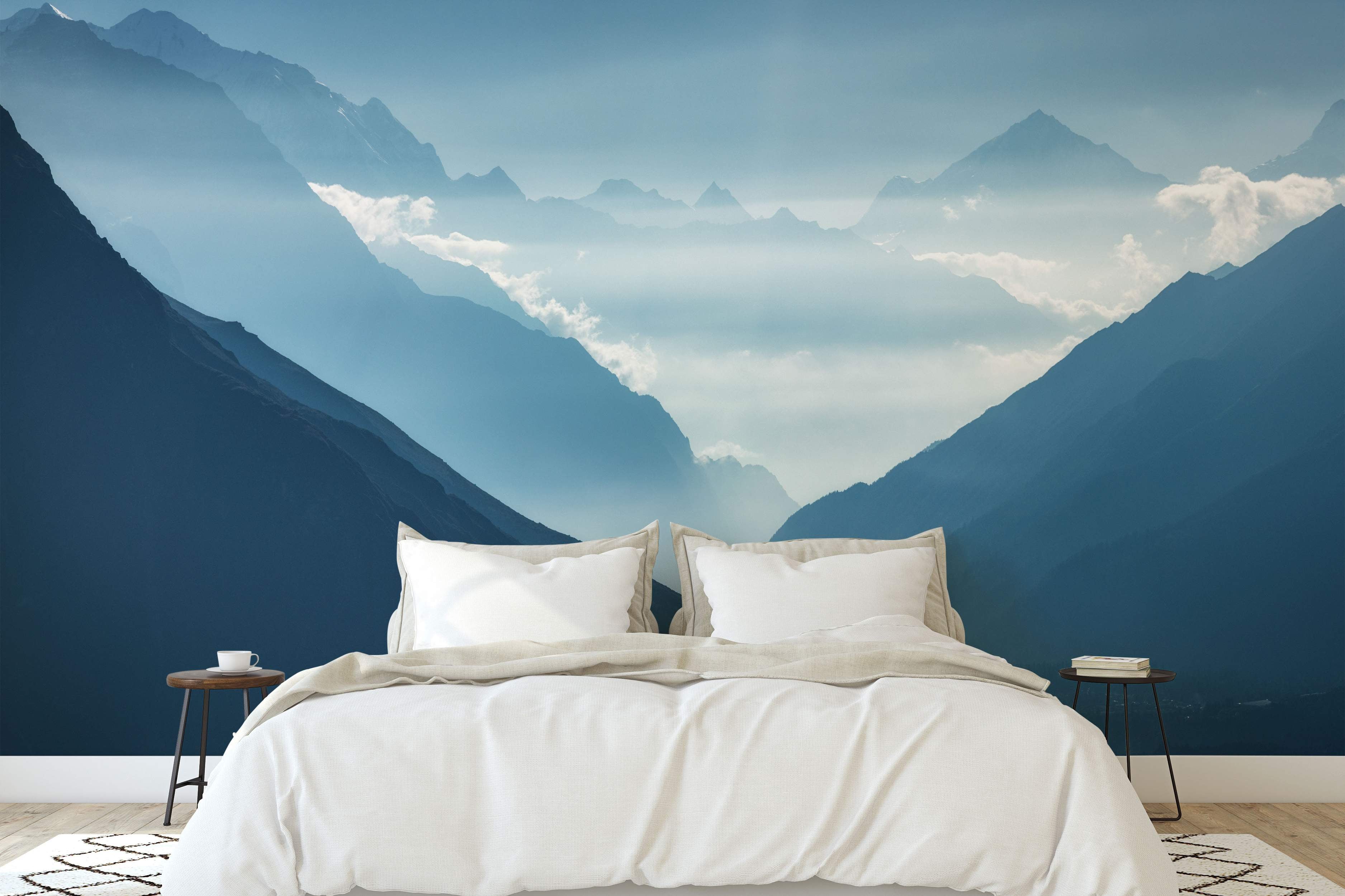 Mural depicting layers of serene blue mountains fading into distant white mist, creating atmospheric perspective.