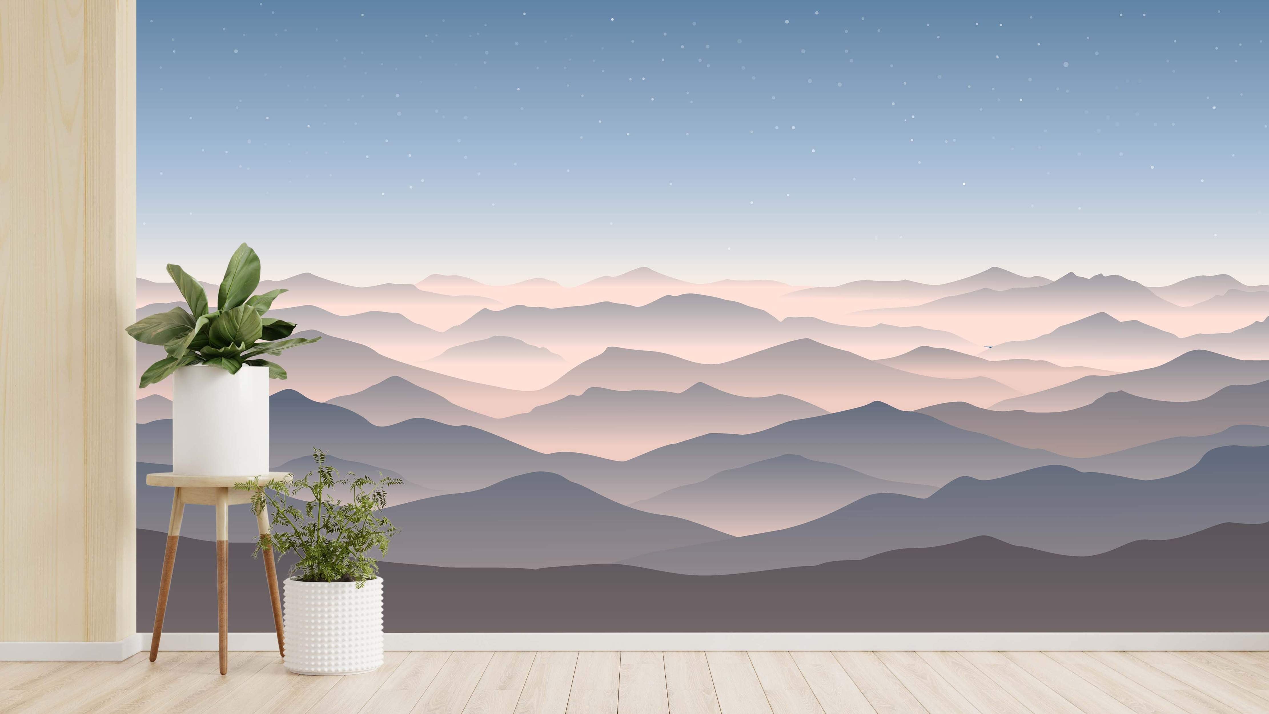 Scenic mural of hazy mountain layers in pale pink, purple, and gray tones beneath a fading blue, starry sky.