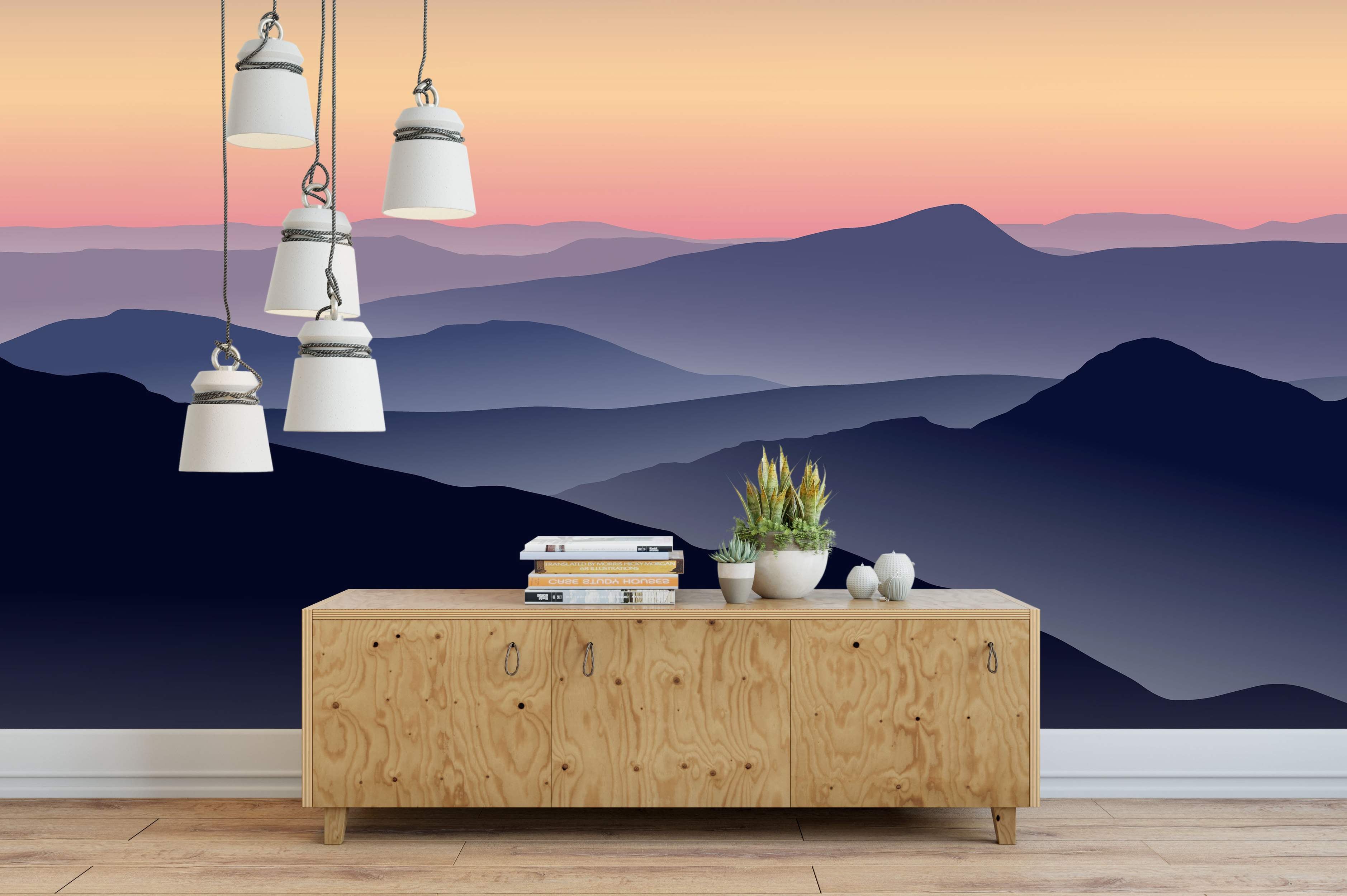 Mural featuring layered mountain silhouettes in deep blues and purples under a gradient sky transitioning from pink to pale orange.