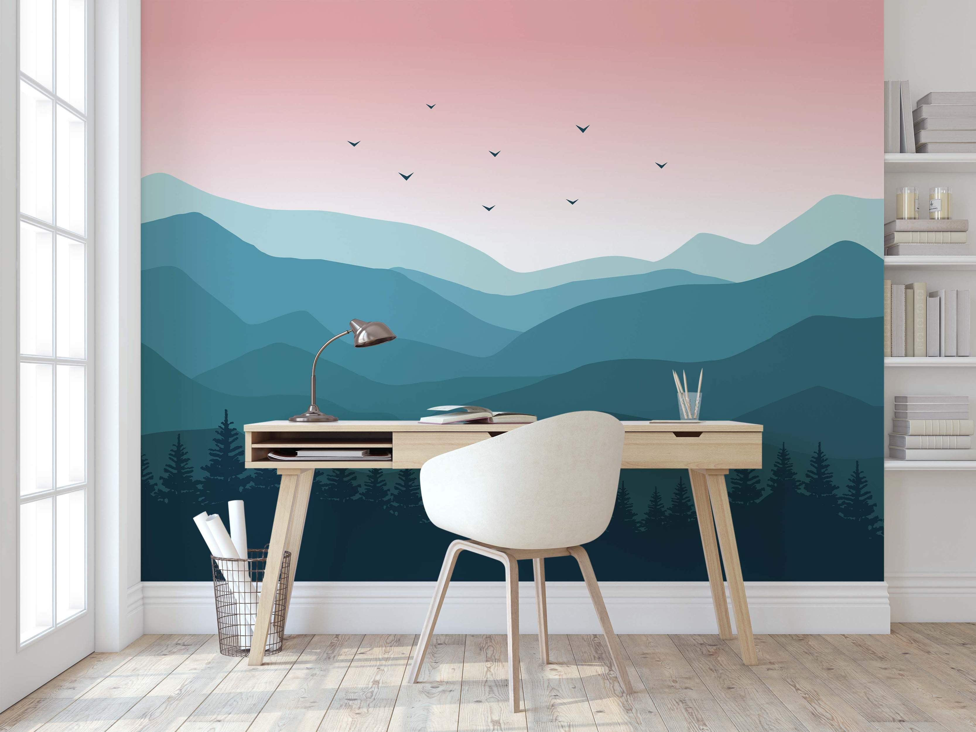 Mural depicting a stylized mountain range in layered shades of blue and teal below a pink gradient sky with silhouetted birds.