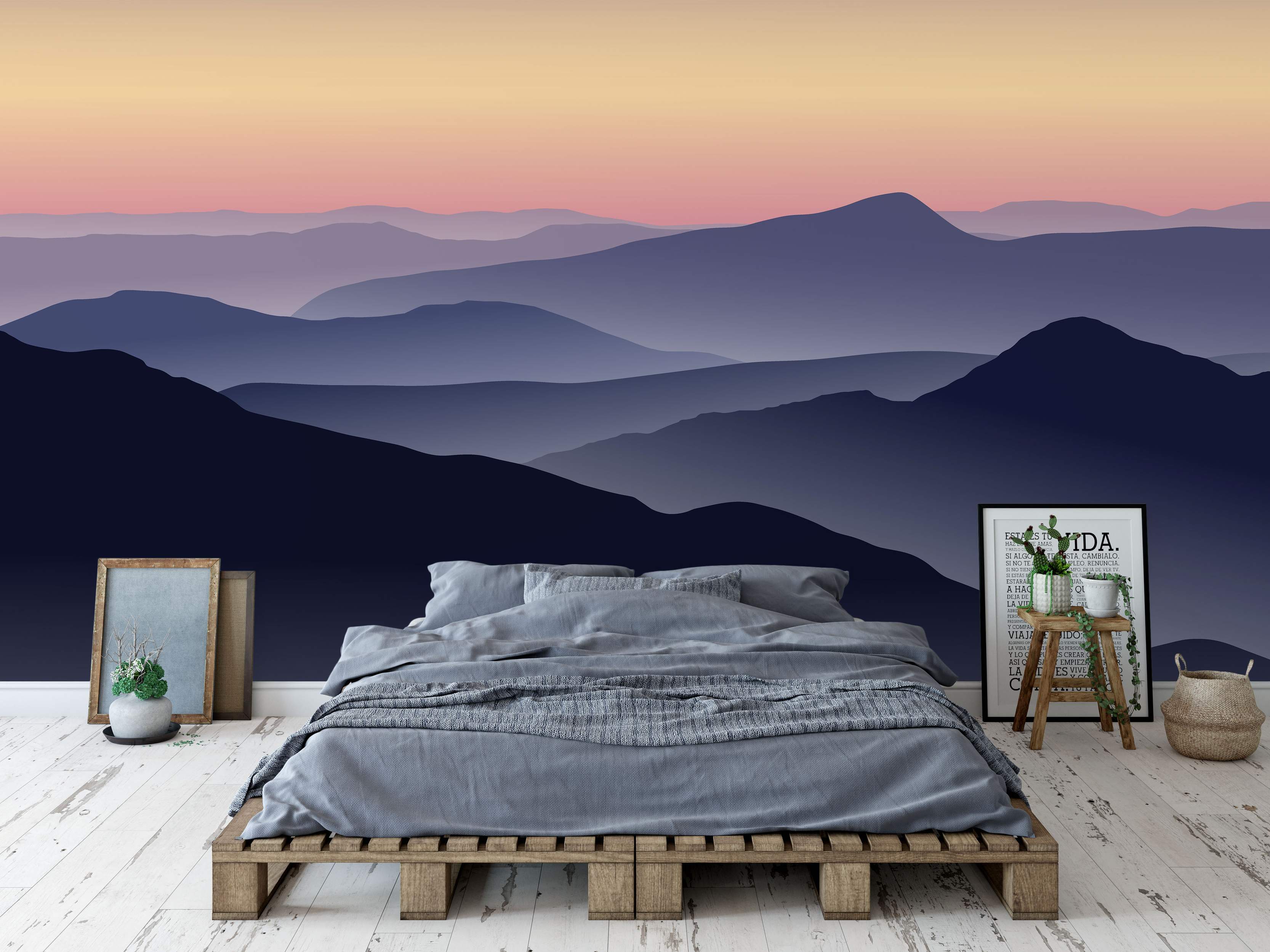 Mountain landscape mural featuring layered silhouettes in deep blue and purple under a pink and orange gradient sunset sky.