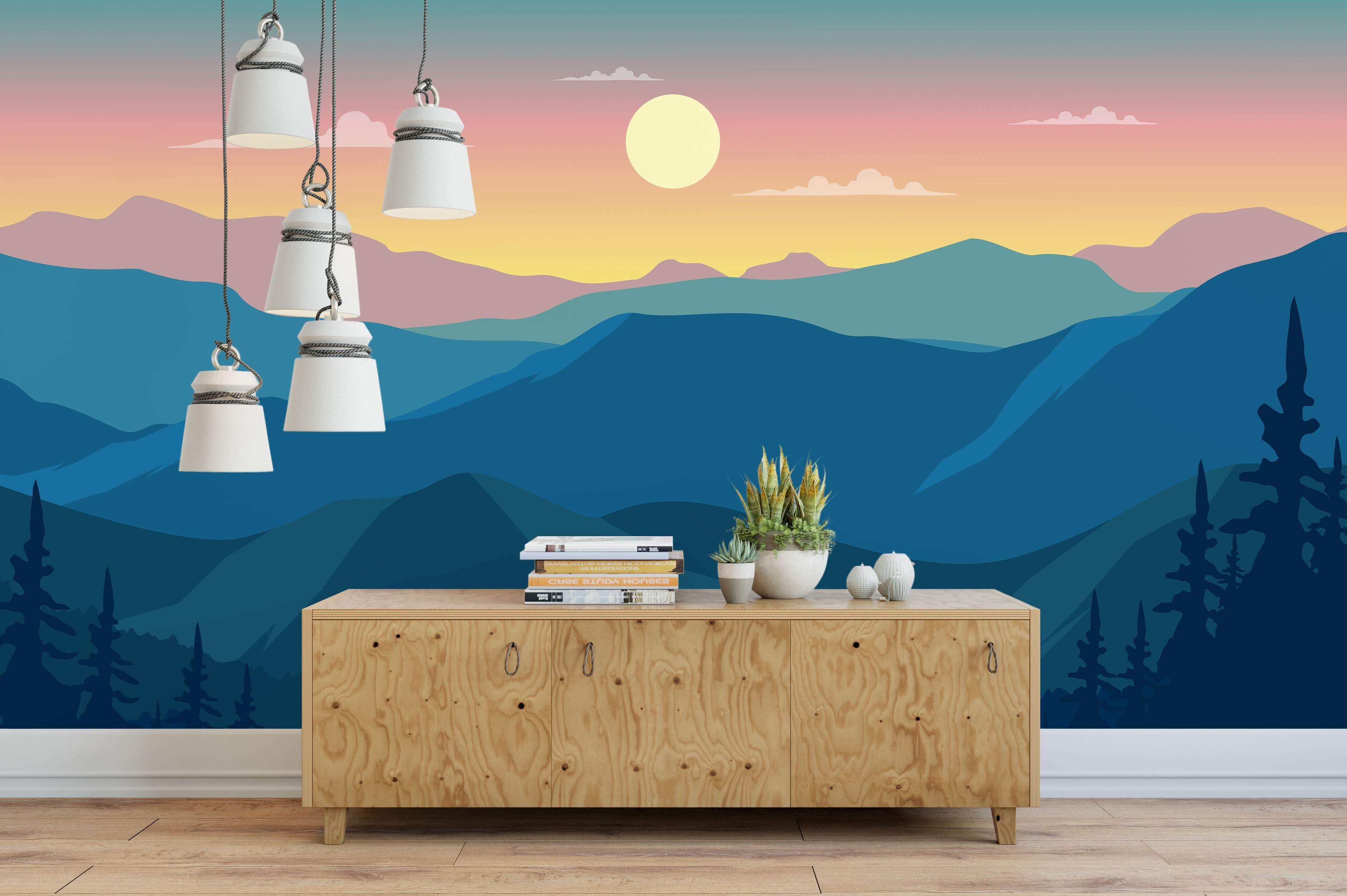 Minimalist mountain landscape mural with layered blue ranges under a pink, orange, and yellow gradient sky with a pale sun.