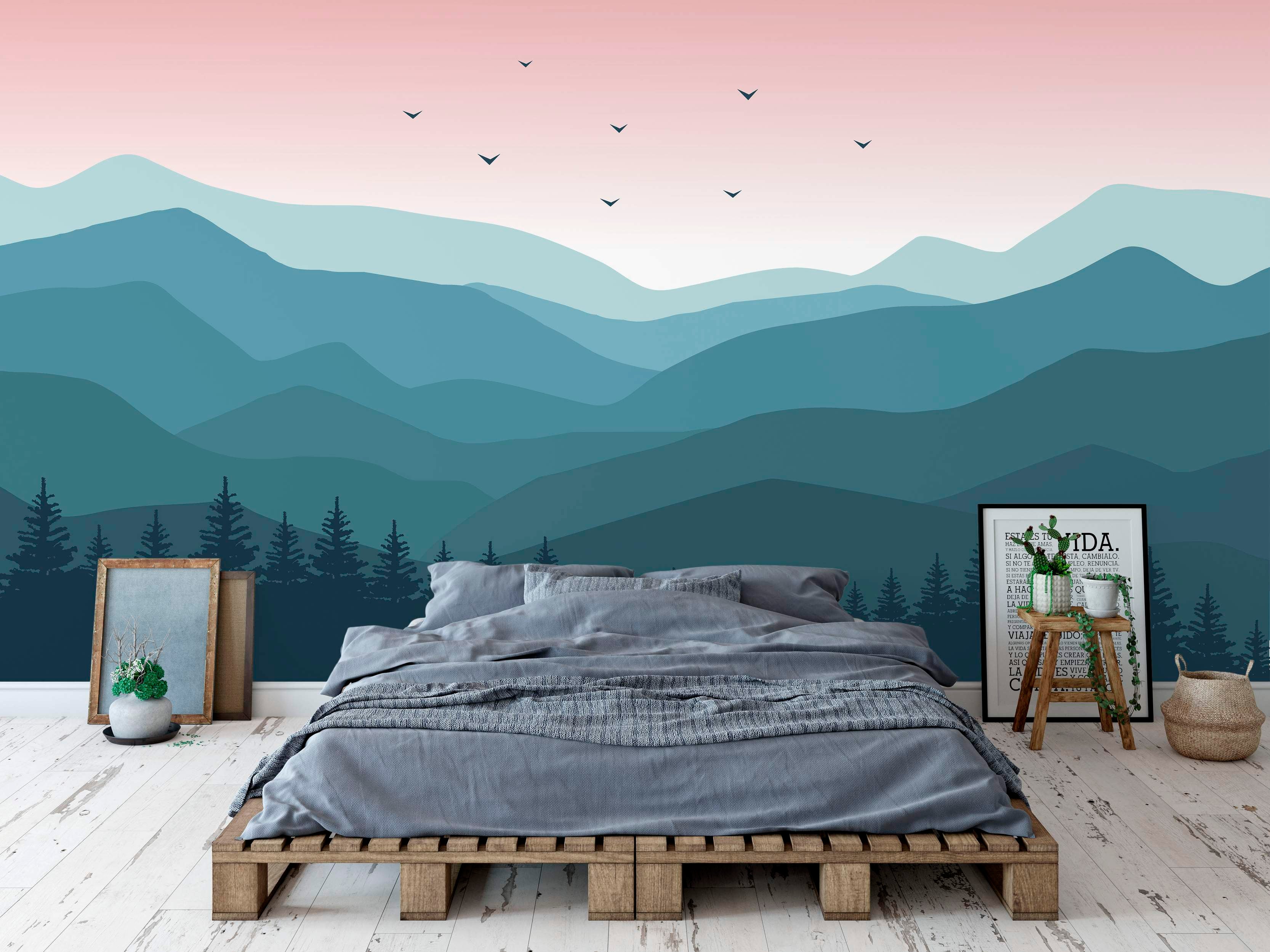 Stylized mountain landscape mural featuring layered teal and blue hills under a soft pink sky with flying bird silhouettes.