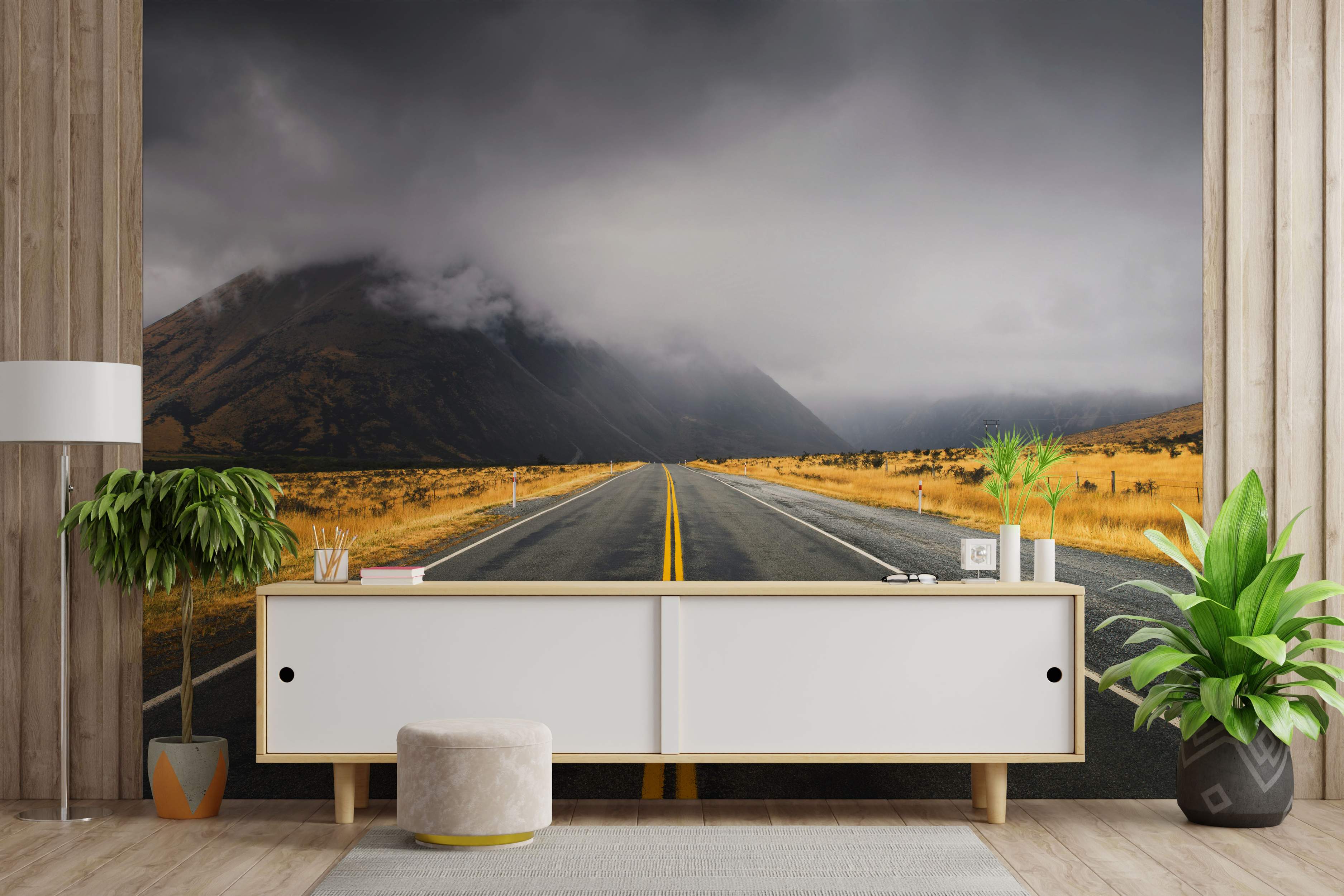 Mural showing a road stretching into mountains under dark clouds