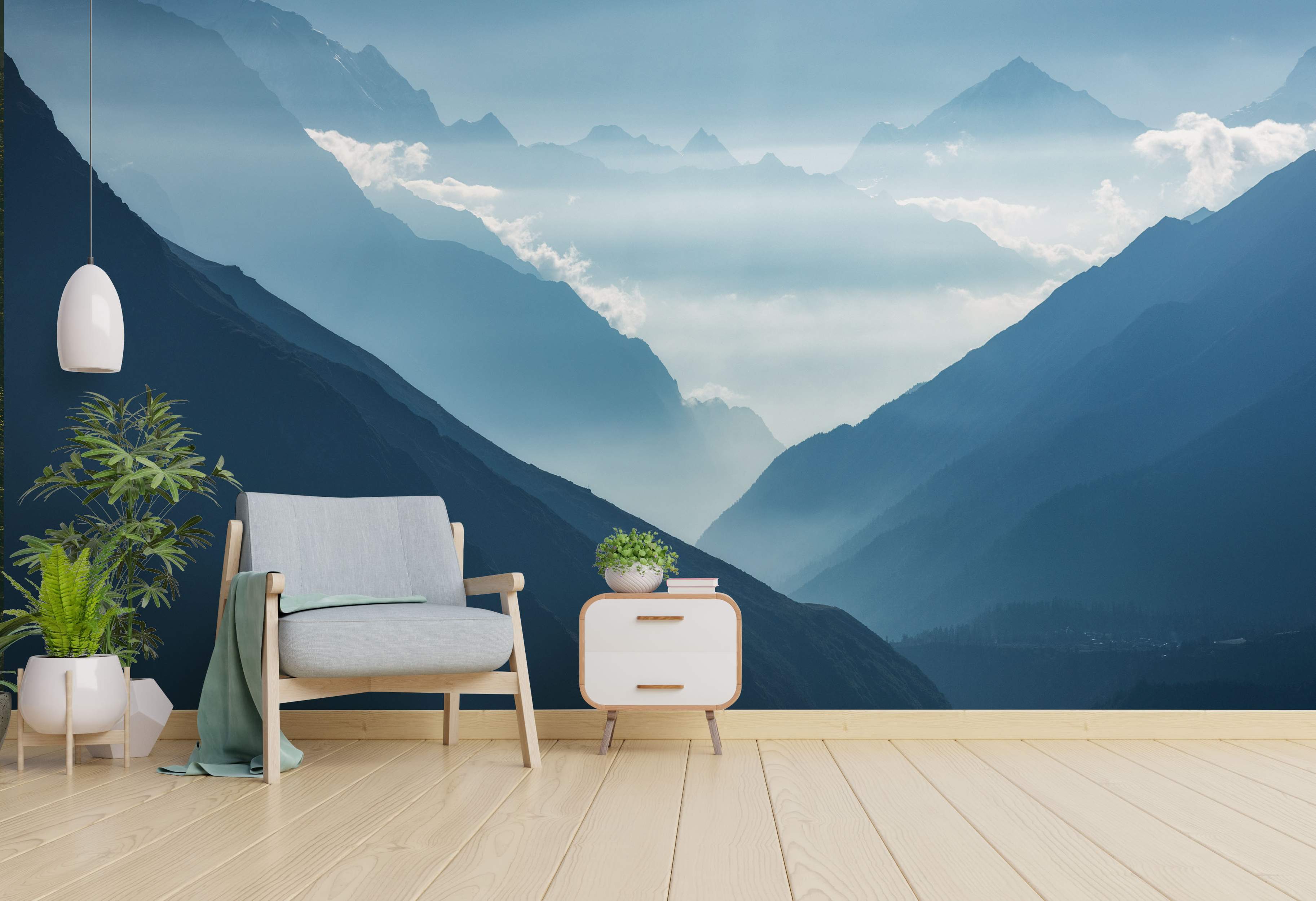 Scenic wall mural of layered blue mountain ranges receding into a hazy valley filled with soft clouds.